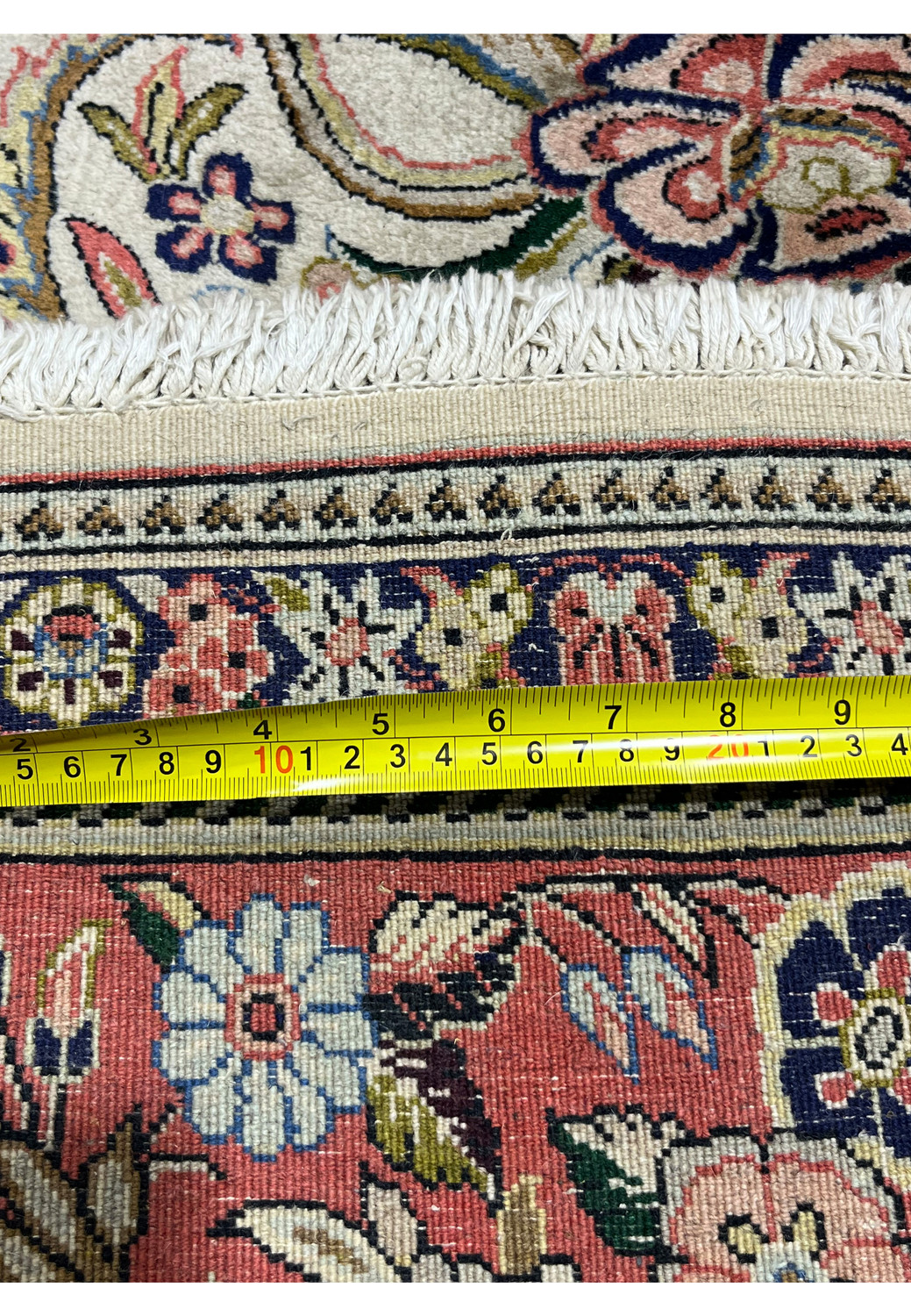 Back of 7x10 Persian Bijar rug with ruler illustrating dense construction cotton foundation and firm weave