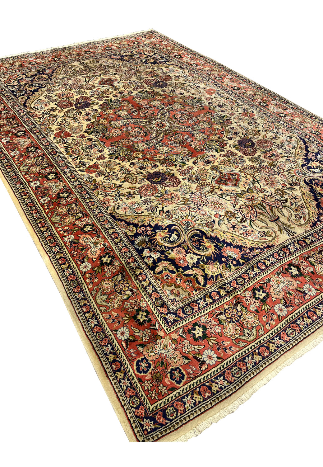7x10 Persian Bijar rug angled view showing ivory field coral medallion navy spandrels and dense floral border