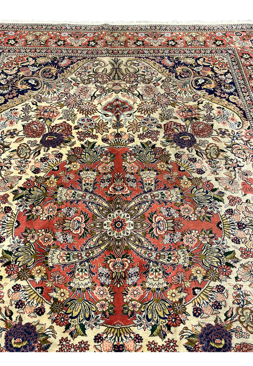 Upper section of Persian Bijar rug featuring navy corner spandrels ivory field and elaborate floral bouquets