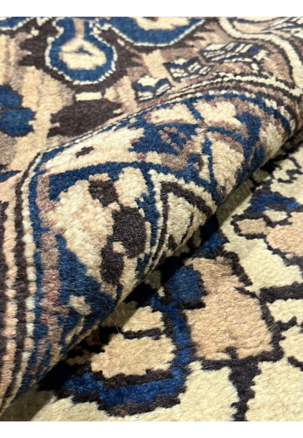 Rolled edge of 11x13'3 Vintage Persian Heriz rug highlighting thick hand knotted wool pile in muted navy, ivory and brown tones