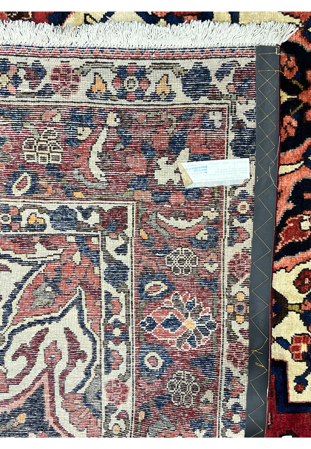 Persian Bakhtiari rug back with ruler showing knot density and cotton warp, hand-knotted wool construction.