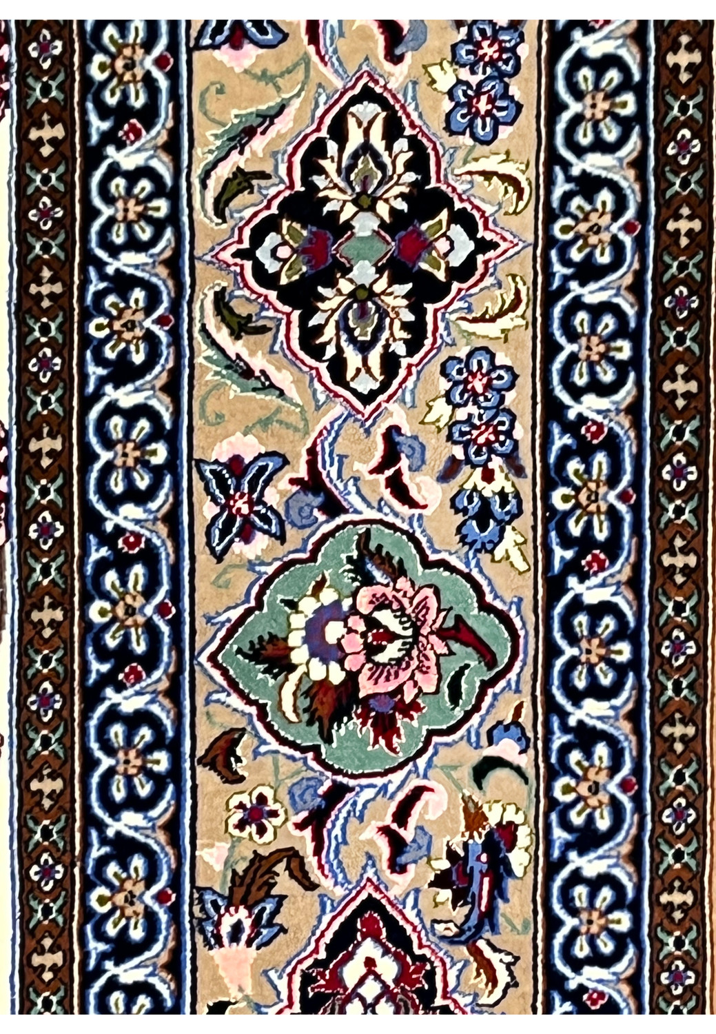 Border closeup Persian Isfahan wool silk rug taupe ground black green cartouches navy arabesque guard stripe