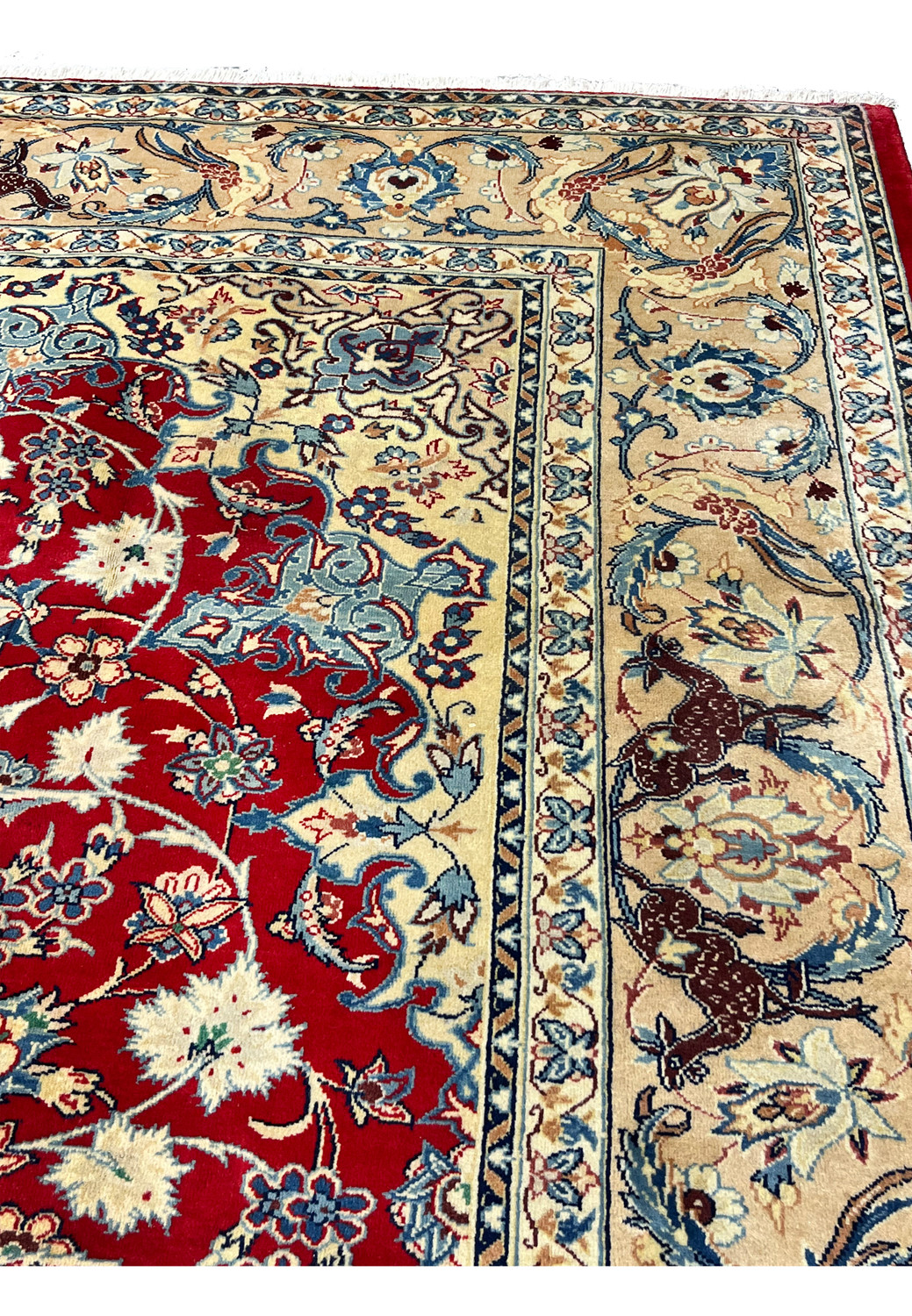 Upper edge detail 10x13 Persian Isfahan wool rug ivory border animal bird motifs blue floral crimson red field fringe