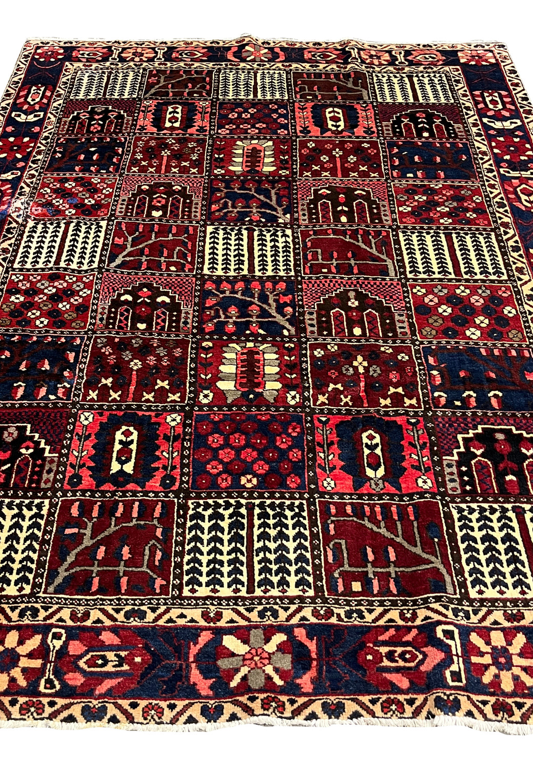 Center field view of 7x10 Persian Bakhtiari rug with garden panel motifs in red and navy