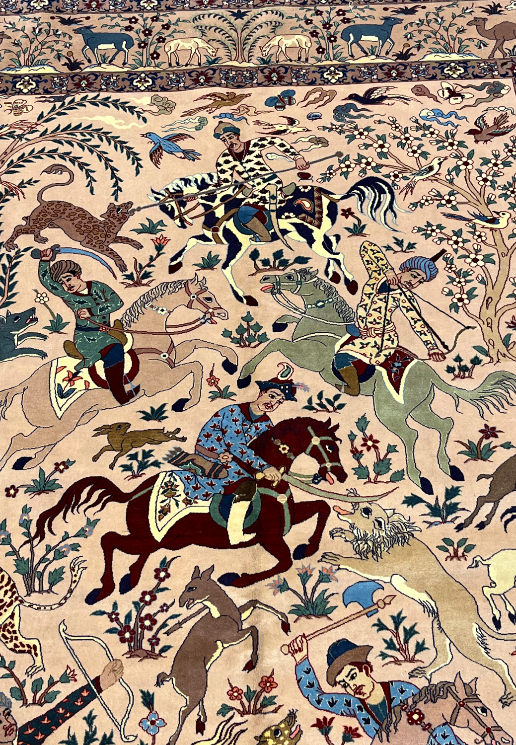 Hunter and horses detail in 5x8 Persian Isfahan Seirafian wool silk rug on blush ground