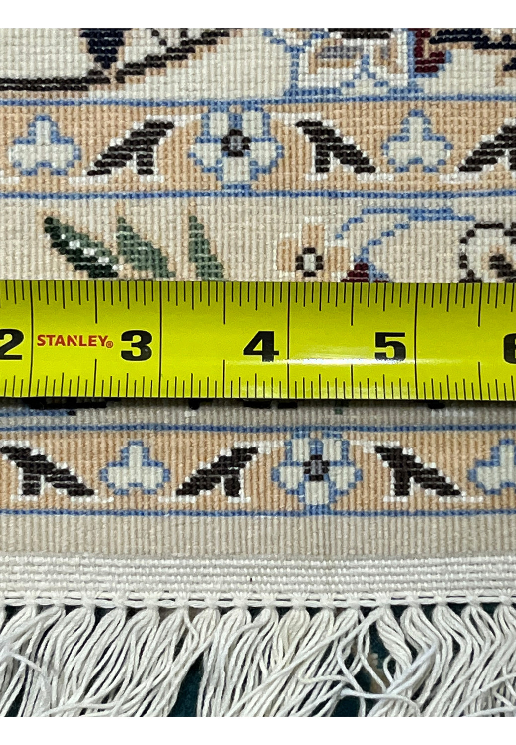 Backside of 7x10 Persian Nain 6La Habibian rug with ruler confirming 309x207cm dimensions