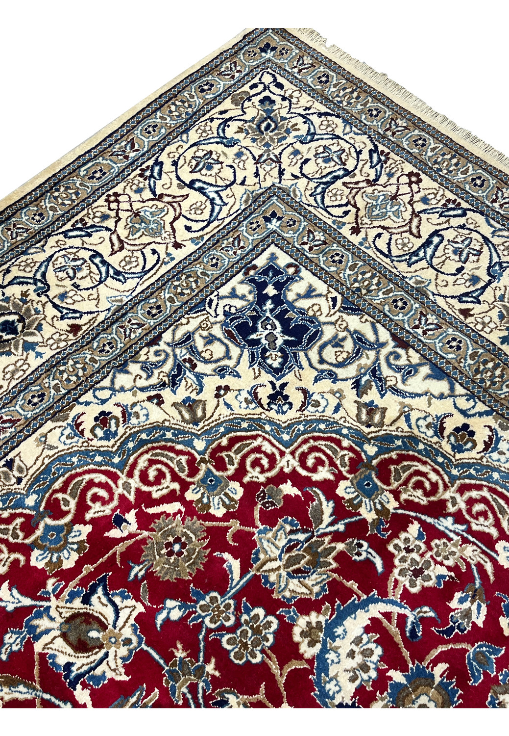 Inner border detail of Persian Nain rug with repeating floral motifs, navy outlines, and precise hand knotted structure