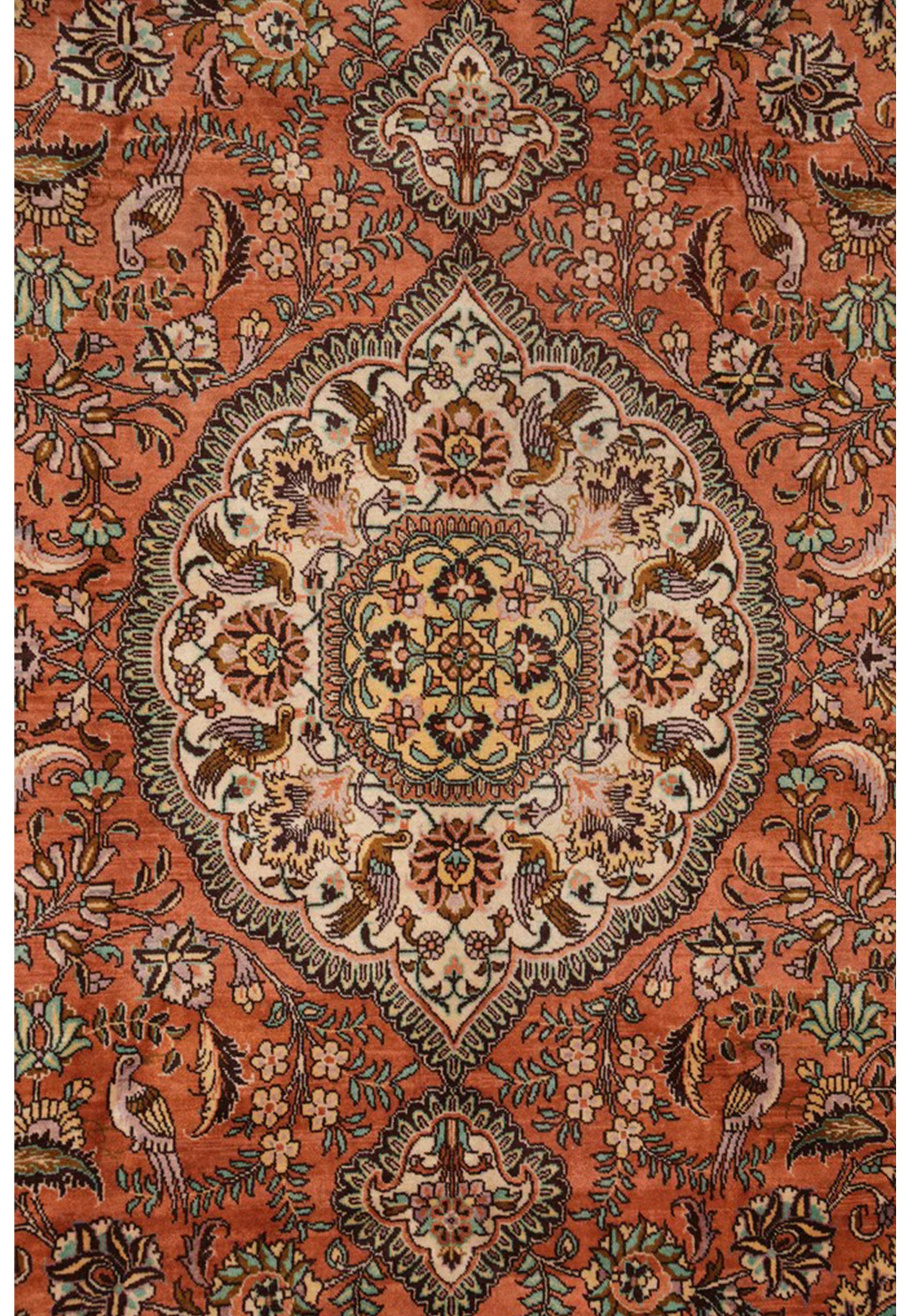 Central medallion close-up of a signed Persian Tabriz Paradies rug with ivory floral geometry, muted gold accents, and refined outlines