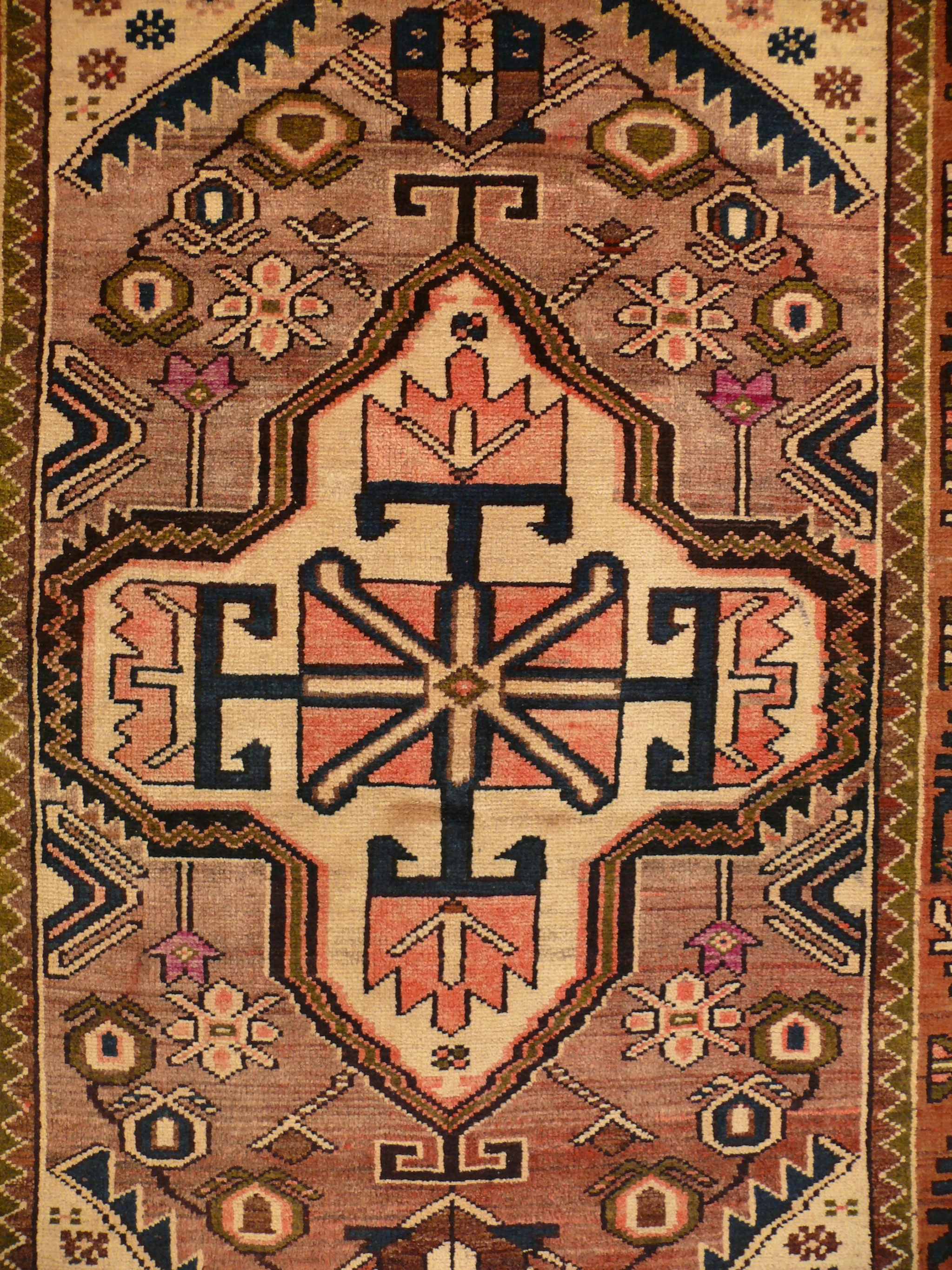 Close-up detail highlighting the intricate tribal motifs on the Persian Khamseh rug