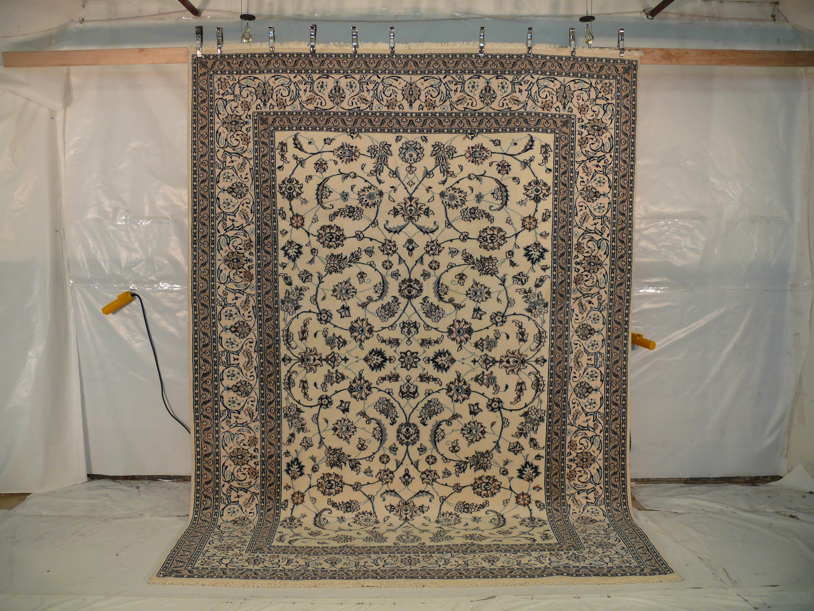 Angled view showing alternating light blue and turquoise details on beige background