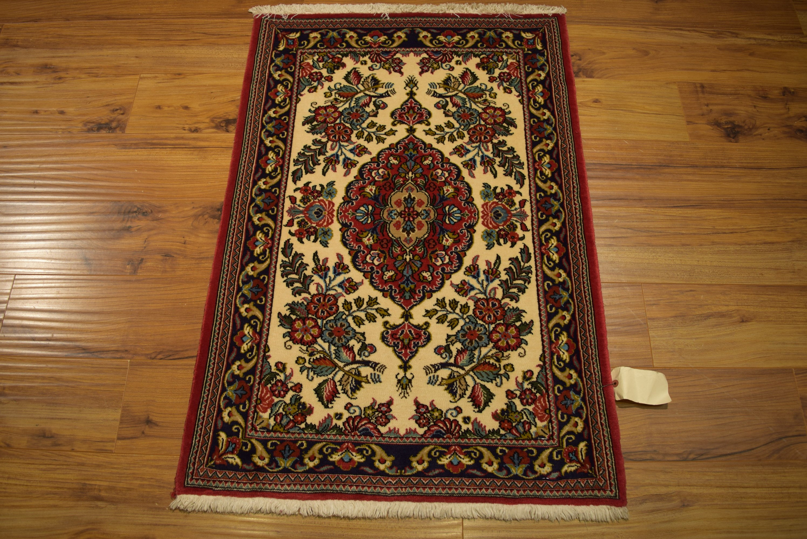 The Persian Qum Kork rug laid out, highlighting its full design and luxurious texture.