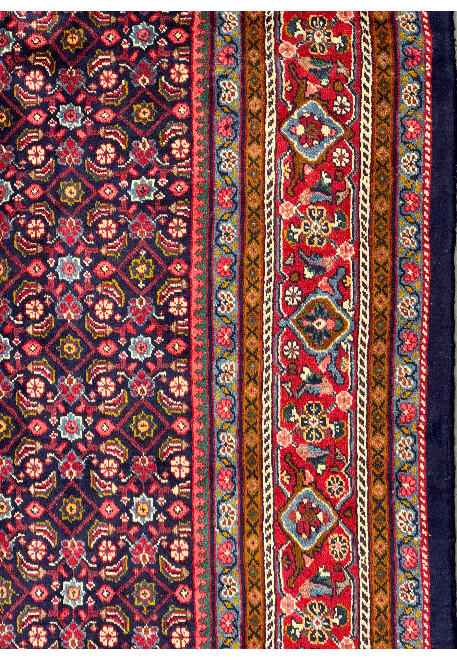 Detailed view of the geometric border and floral central field of the Persian Mahal Rug.