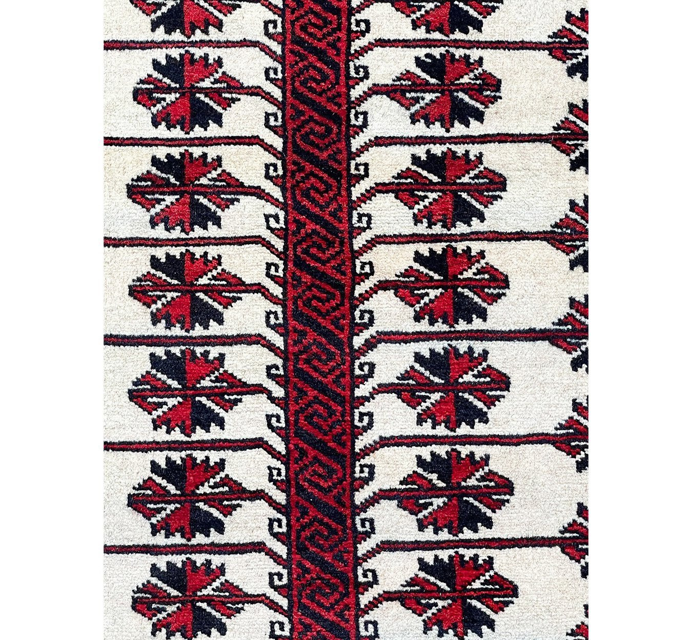 Detailed shot of the diamond-shaped motifs in the middle field of the Persian Baluch rug, highlighting its unique design