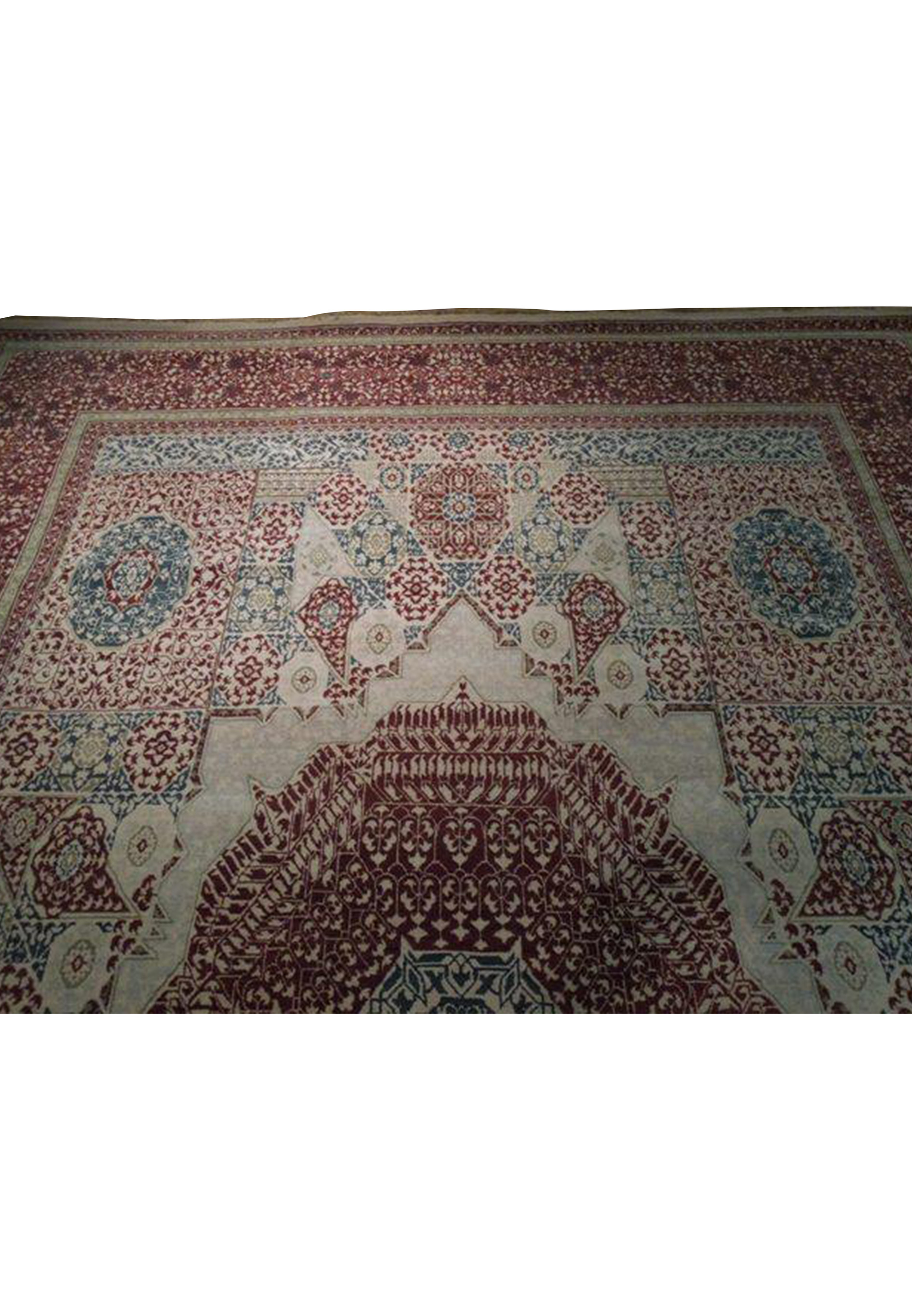 Partial view of a handmade Oriental Agra rug displaying the fine detail of its border and the contrasting cream and navy blue patterns.