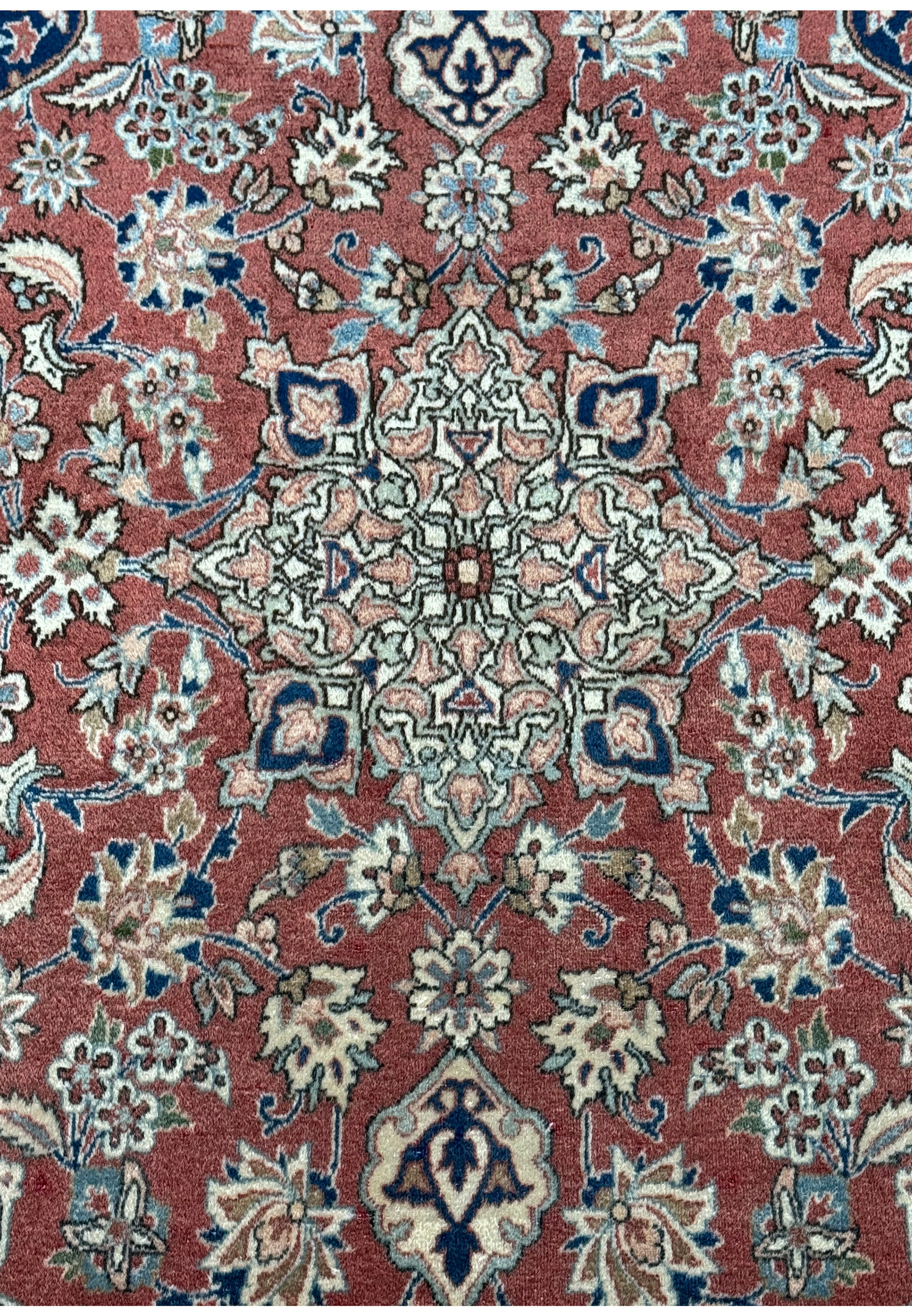Detailed view of the central medallion of a 3x5 Antique Mashad Rug, with a focus on the exquisite design and soft wool texture