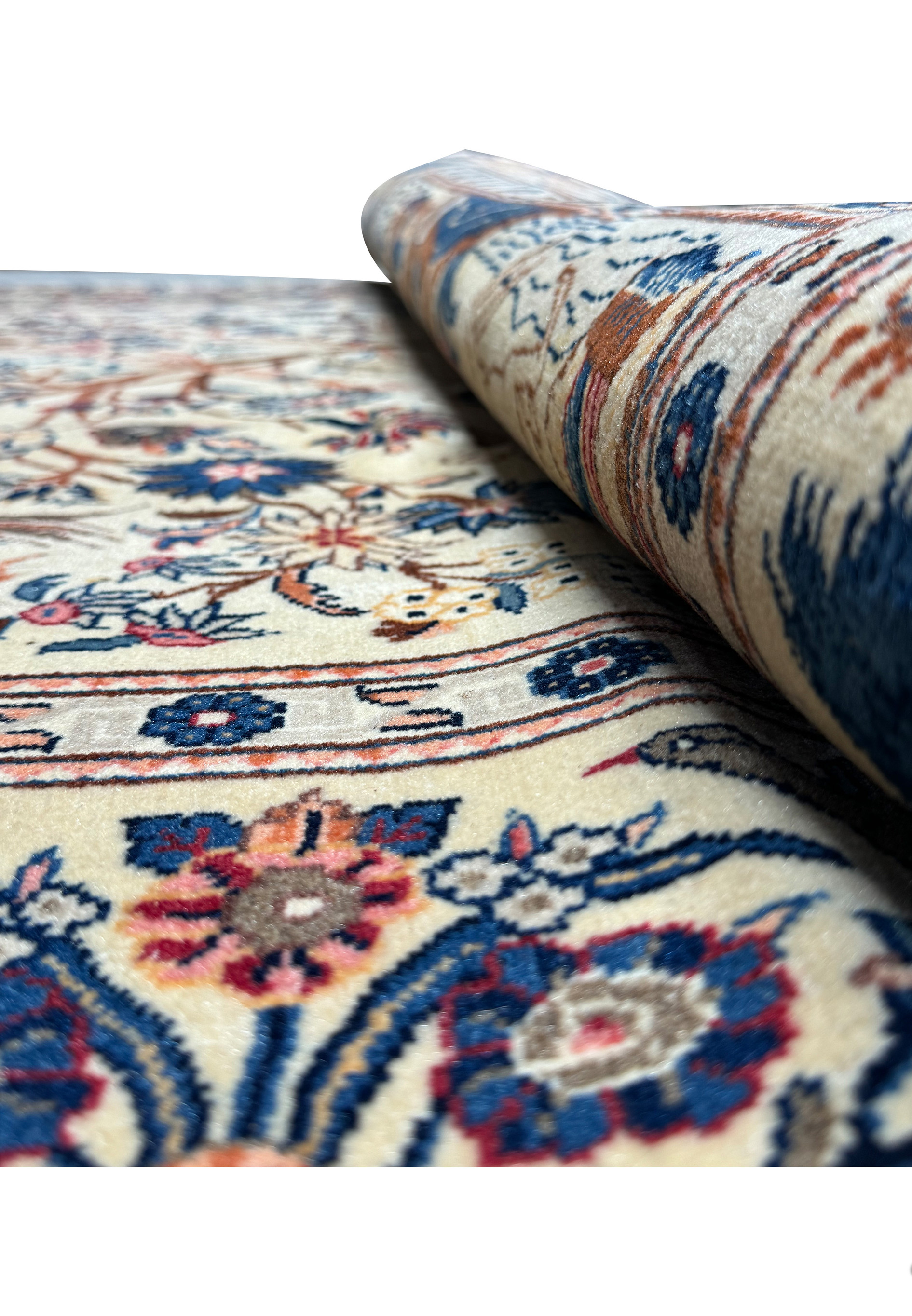 Angled perspective of an Antique Persian Kashan rug, highlighting the depth of the weave and the vibrant colors of the Tree of Life and border designs