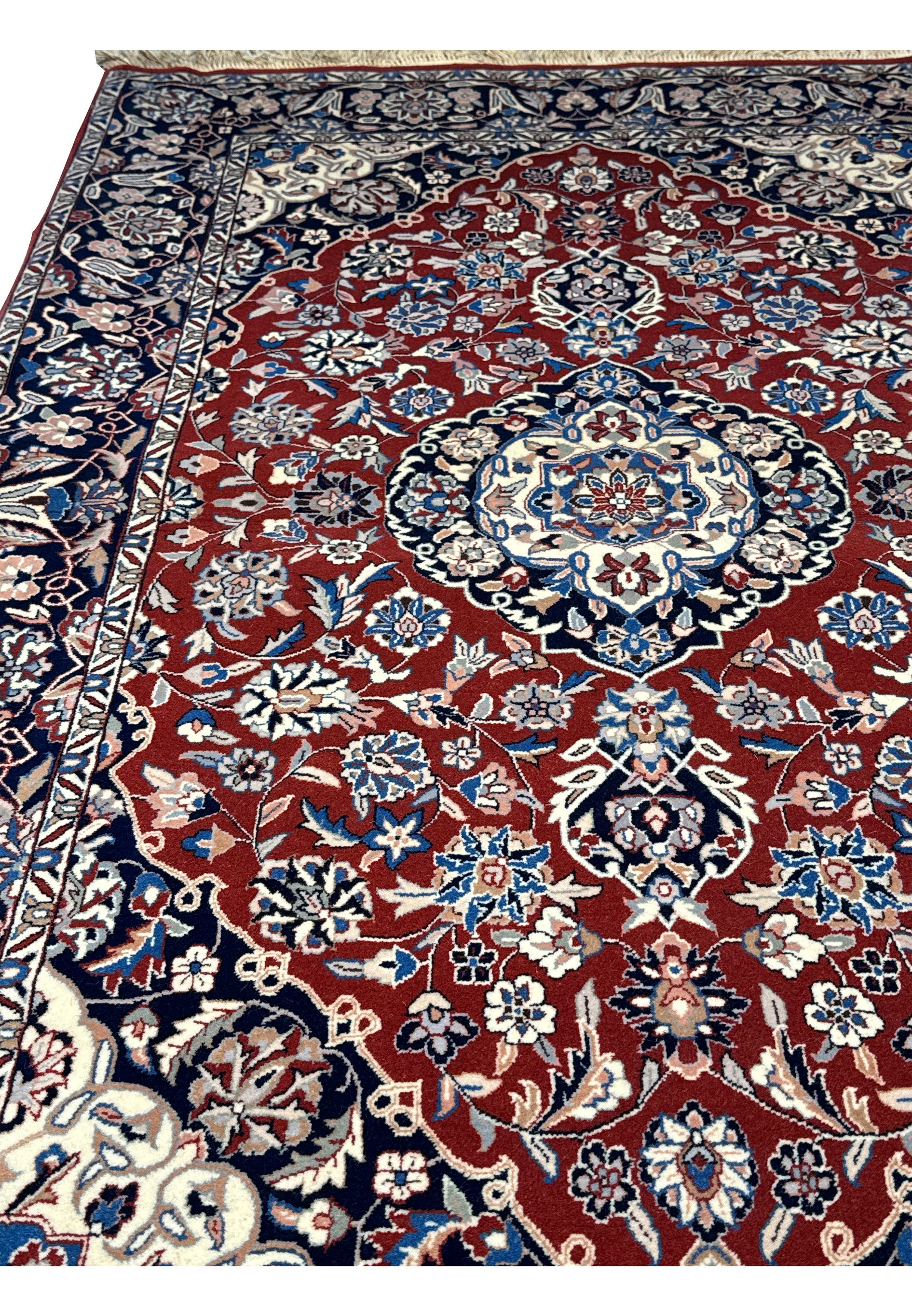Angled perspective of Persian Isfahan rug emphasizing the texture and color variation