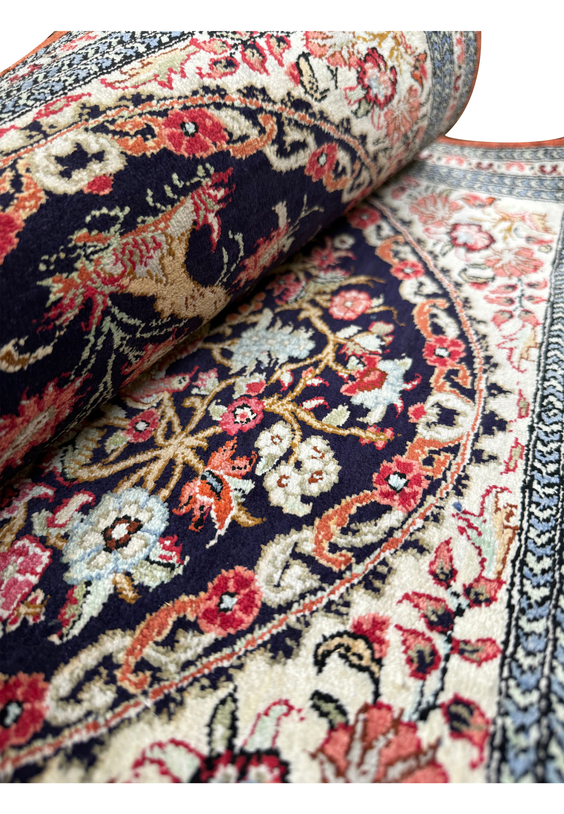 Folded to show how soft and fine this 2x3 Persian Qum Silk rug is.