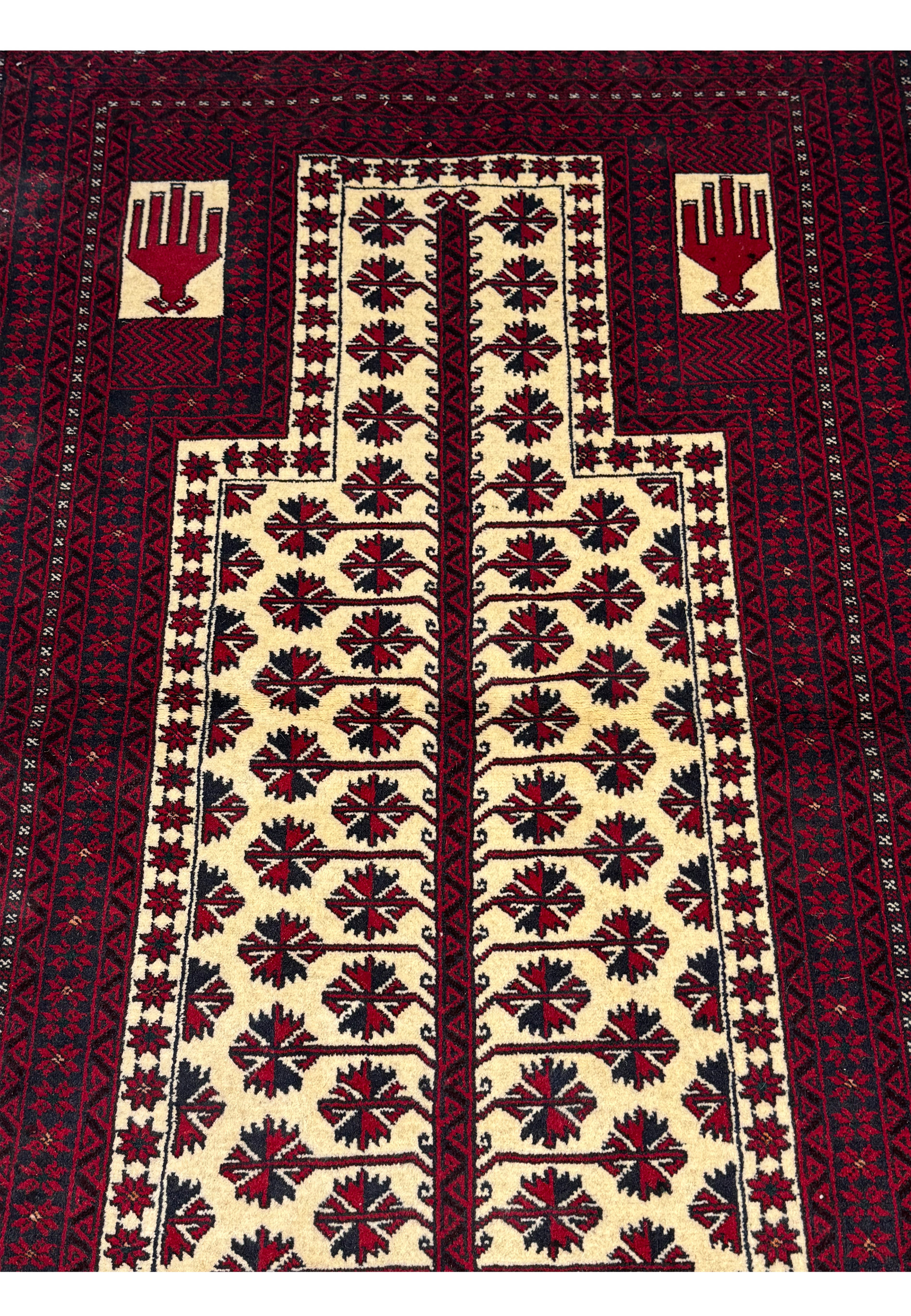 Angled shot of the Persian Baluch Prayer Rug showcasing the depth of color and design intricacy.