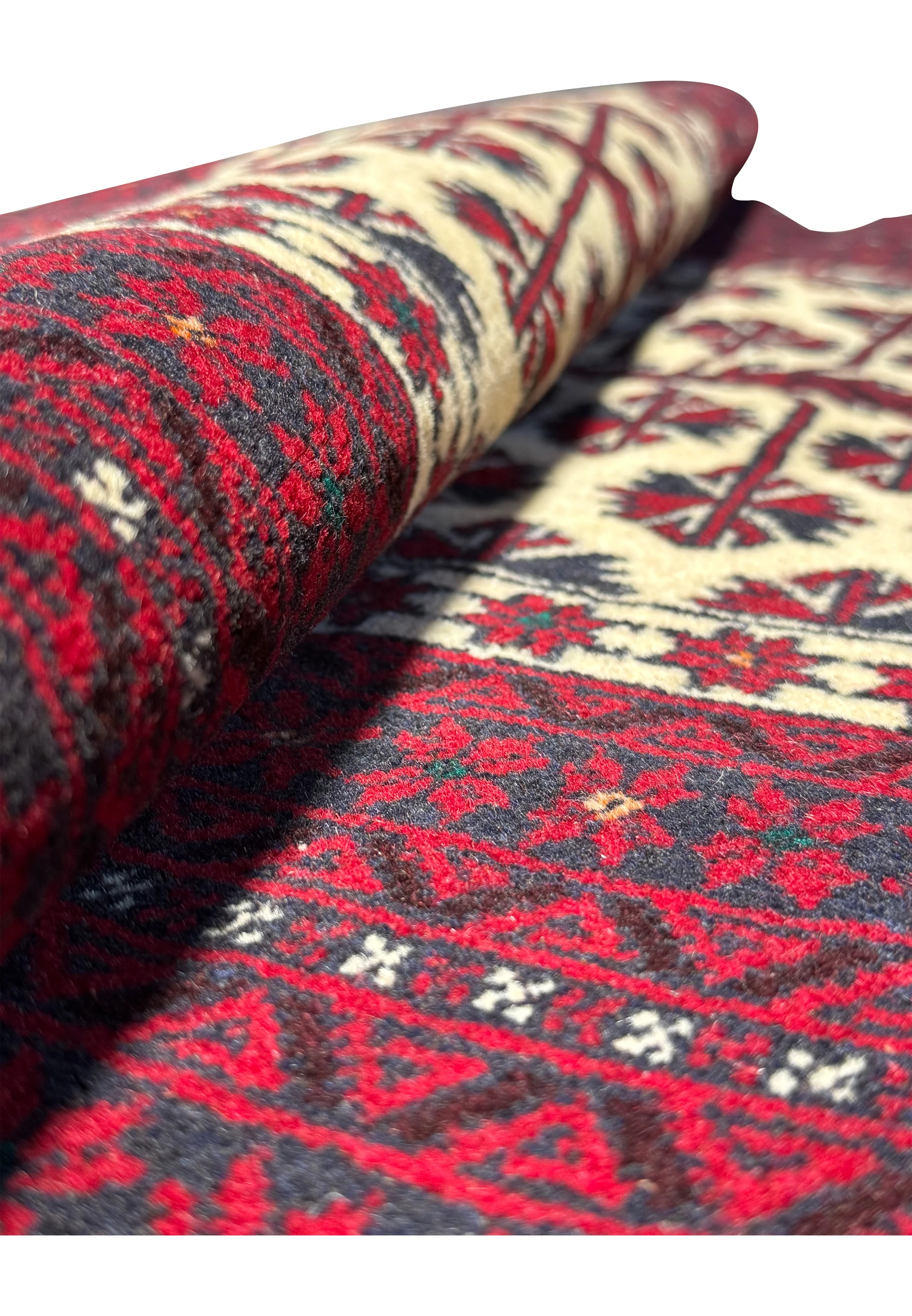 Folded Persian Baluch Prayer Rug, emphasizing the texture and weave quality.