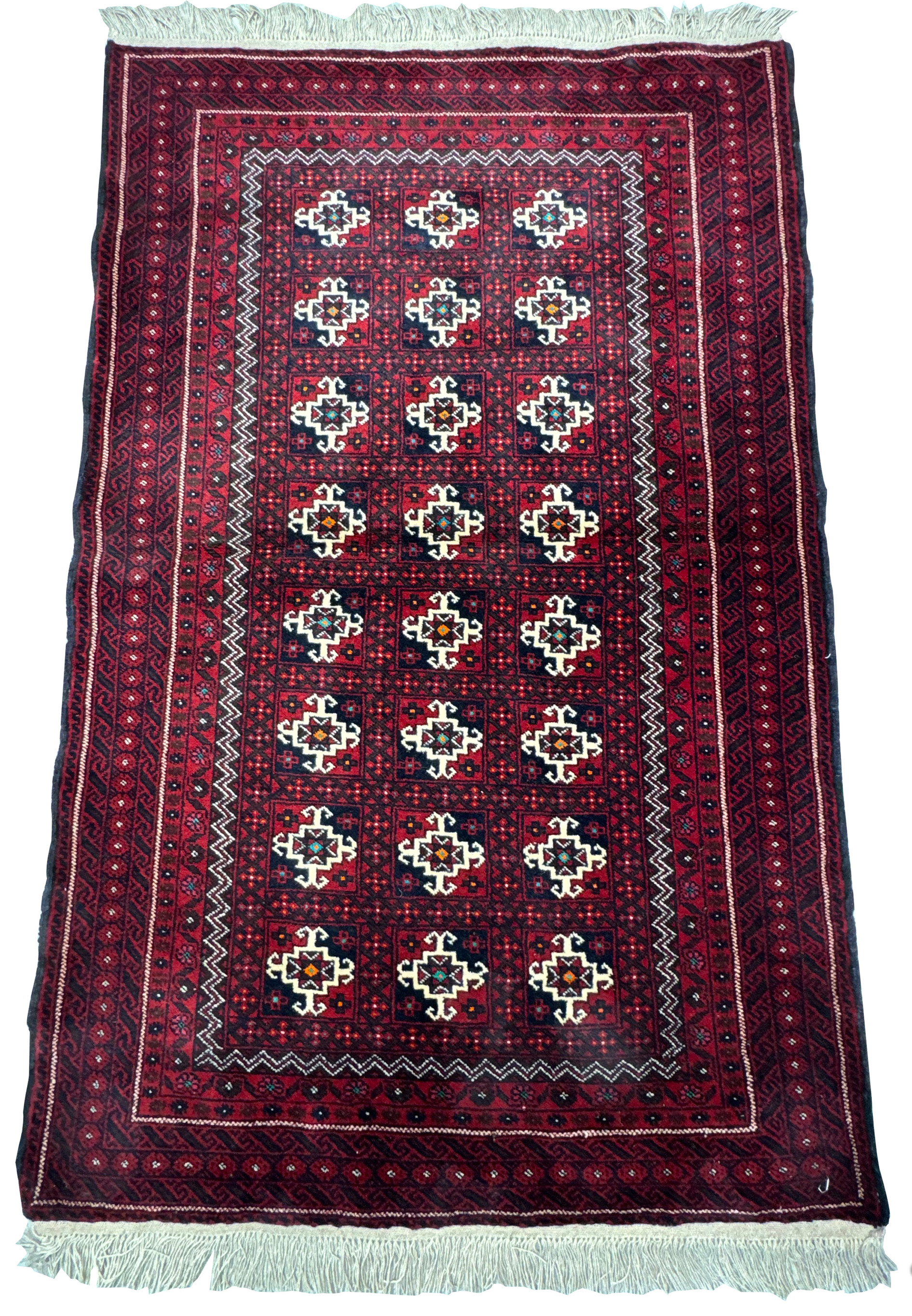 Overhead view of a traditional Persian Baluch rug displaying intricate geometric motifs and a multi-layered border design