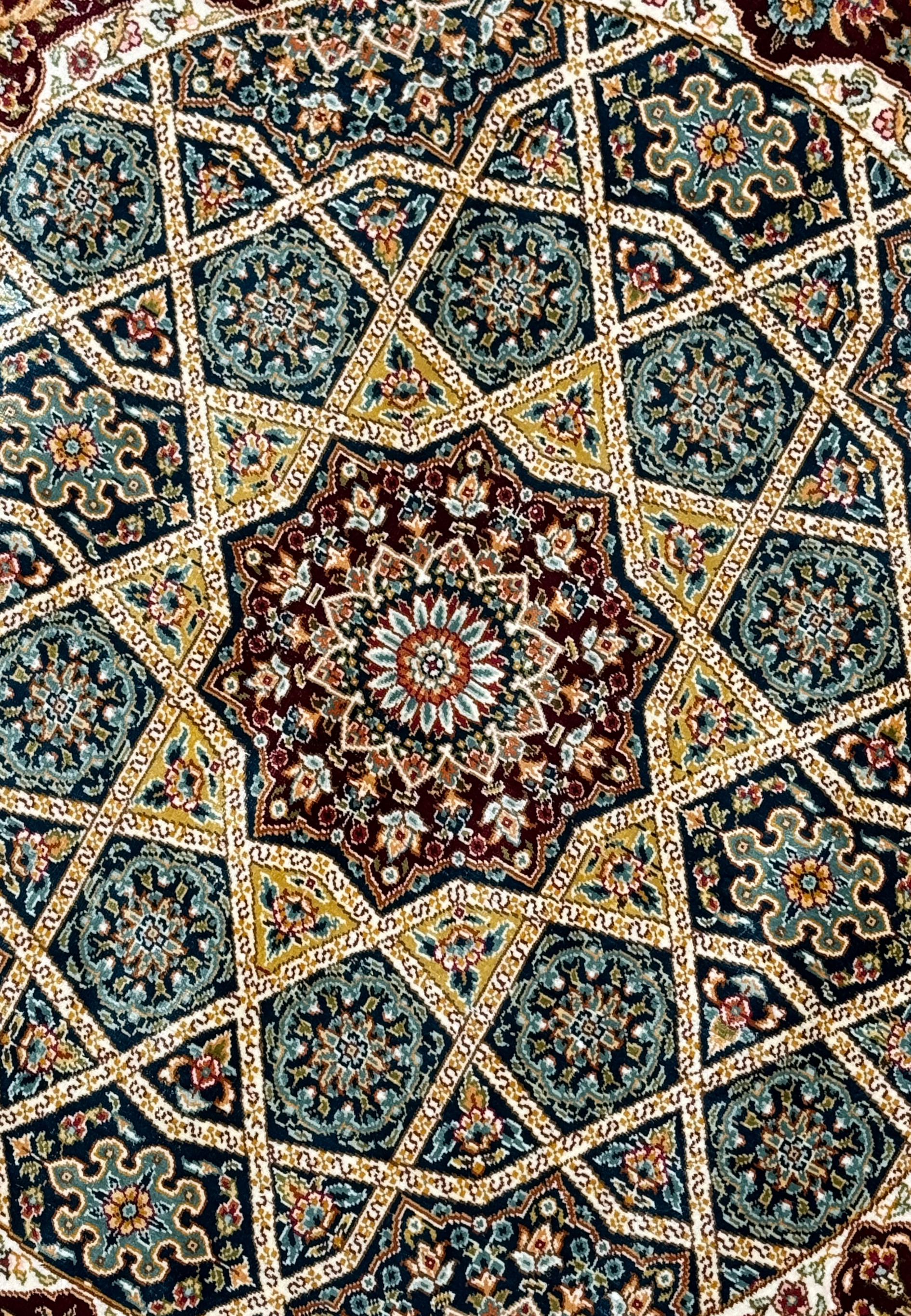 Close-up of the detailed craftsmanship on the Persian Qum silk rug showing the complex interplay of patterns and colors