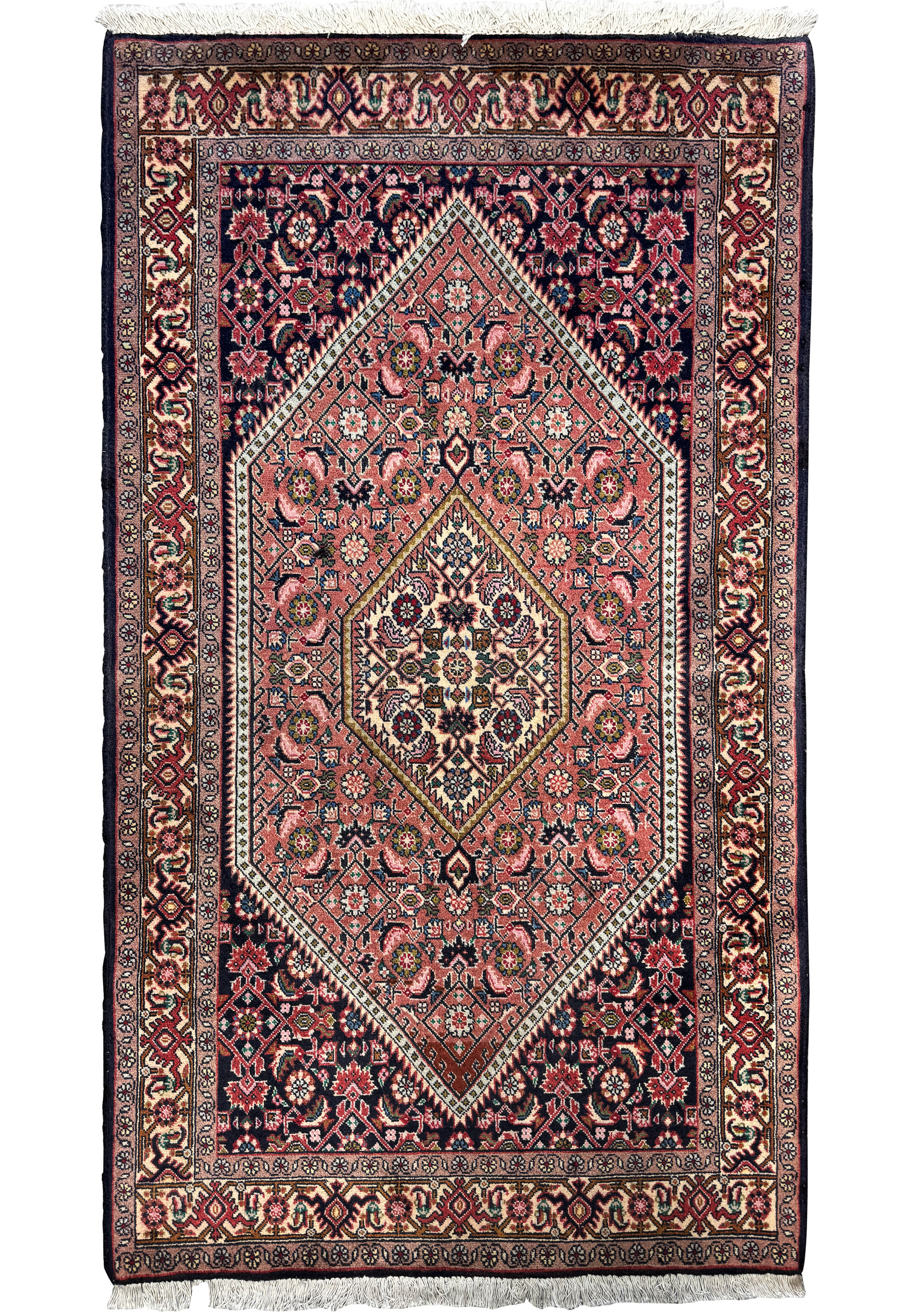 Overhead view of a Persian Bijar rug with a central medallion and intricate designs in navy blue, rust, cream, and pink hues on a deep red background