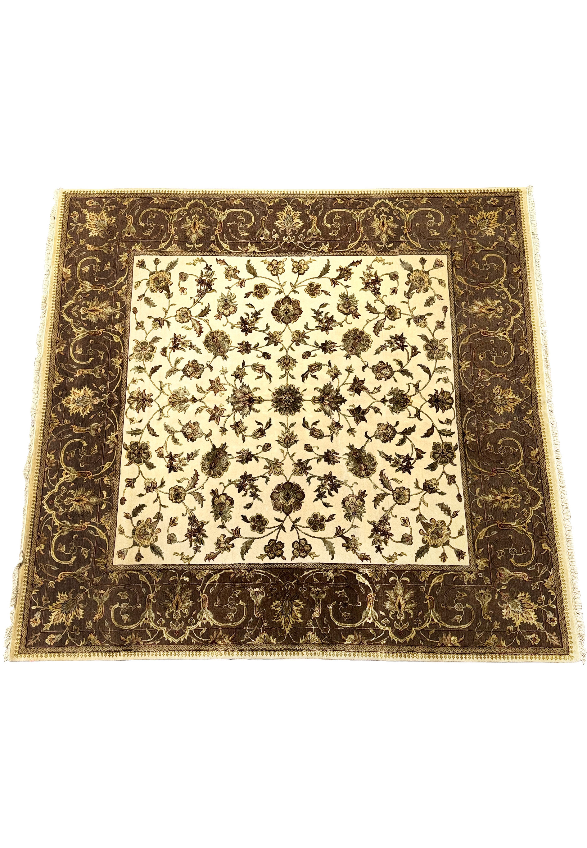 A close-up of the Indian Chobi rug's border, featuring dark brown with intricate vine and floral patterns, alongside a lighter central field of floral designs.