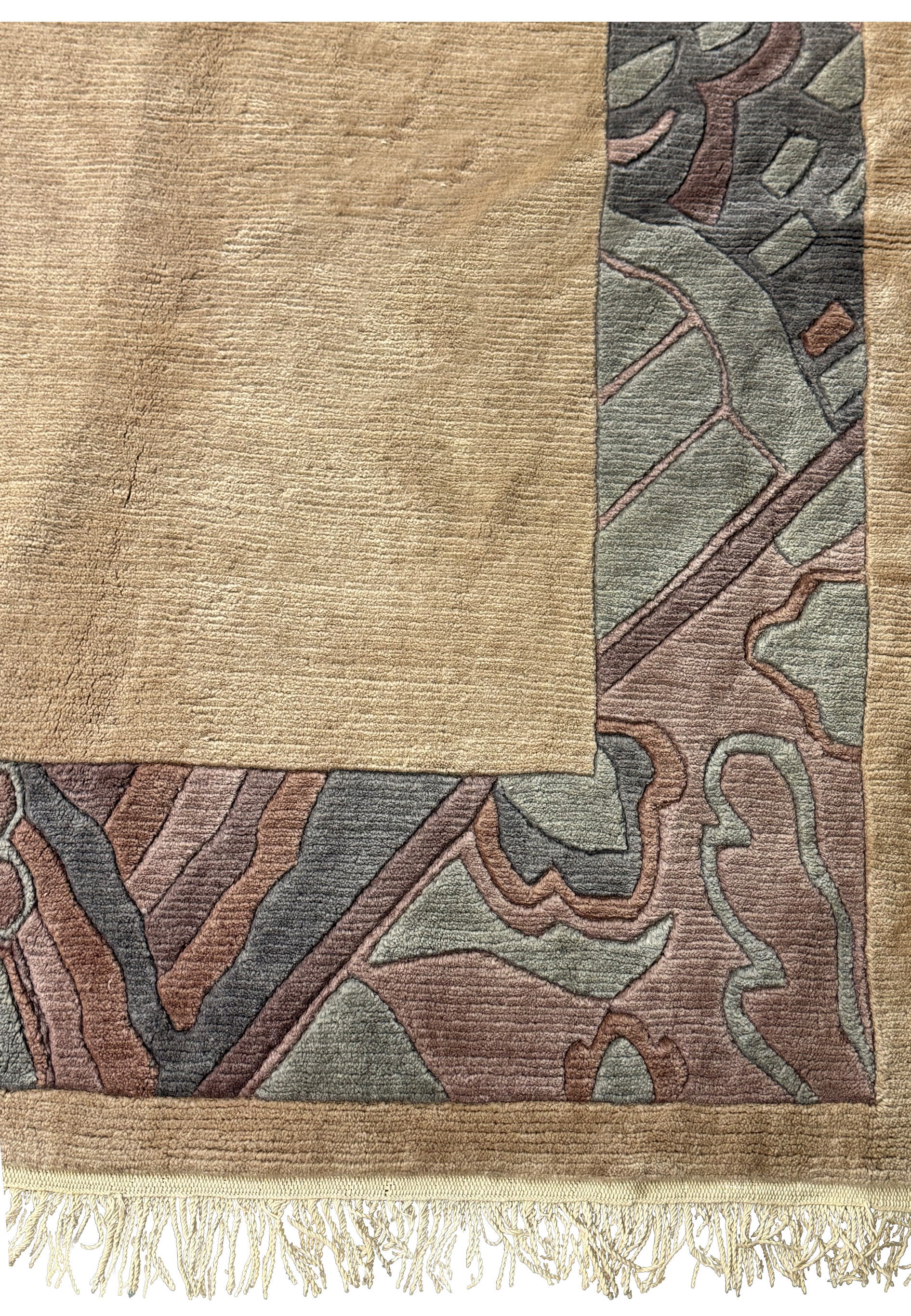 Corner detail of a Modern Royal Tibetan beige rug with intricate border design.