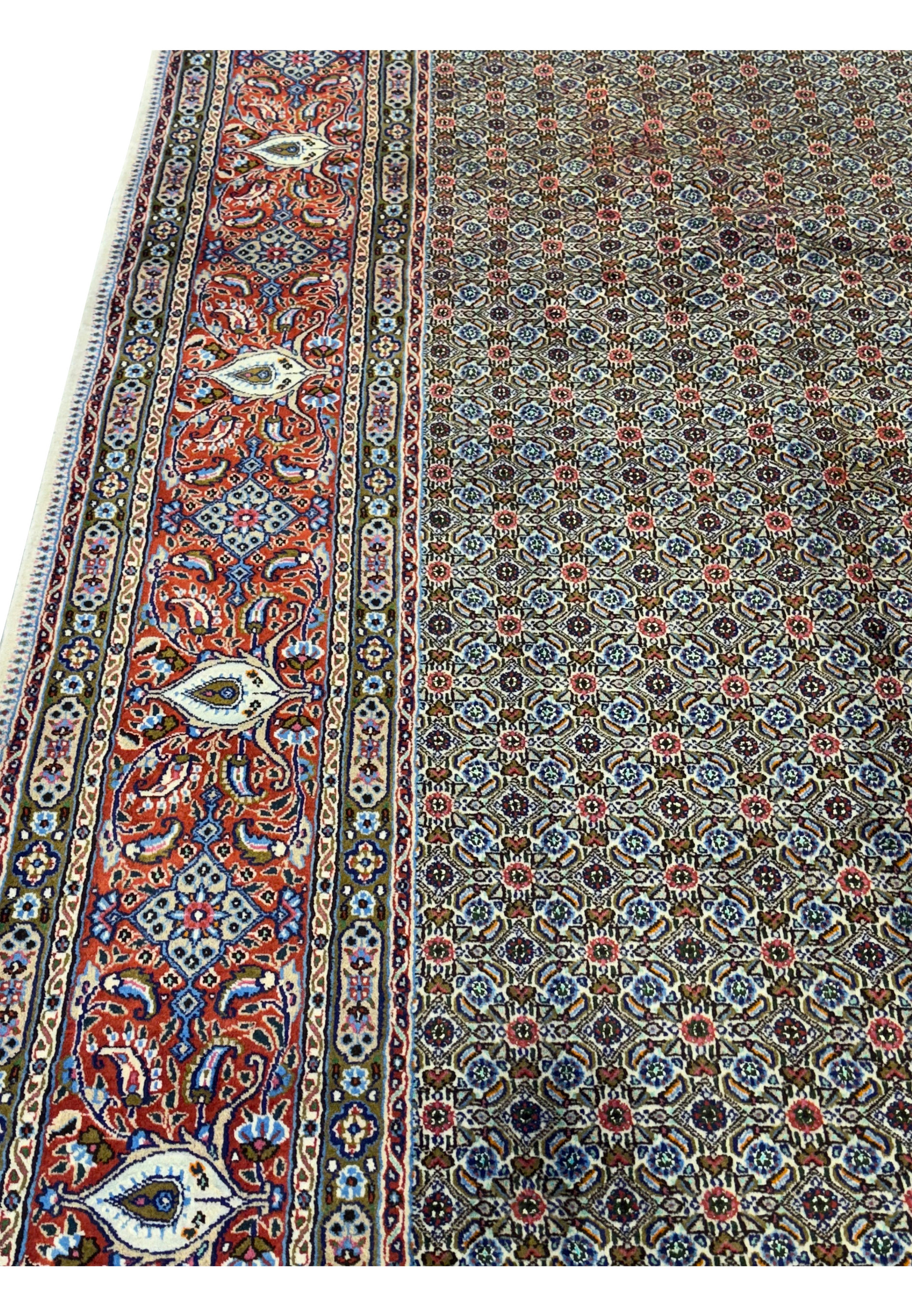 An overhead view of the Persian Moud Rug displaying its all-over pattern alongside the ornate border, laid out flat to reveal the full expanse of its design