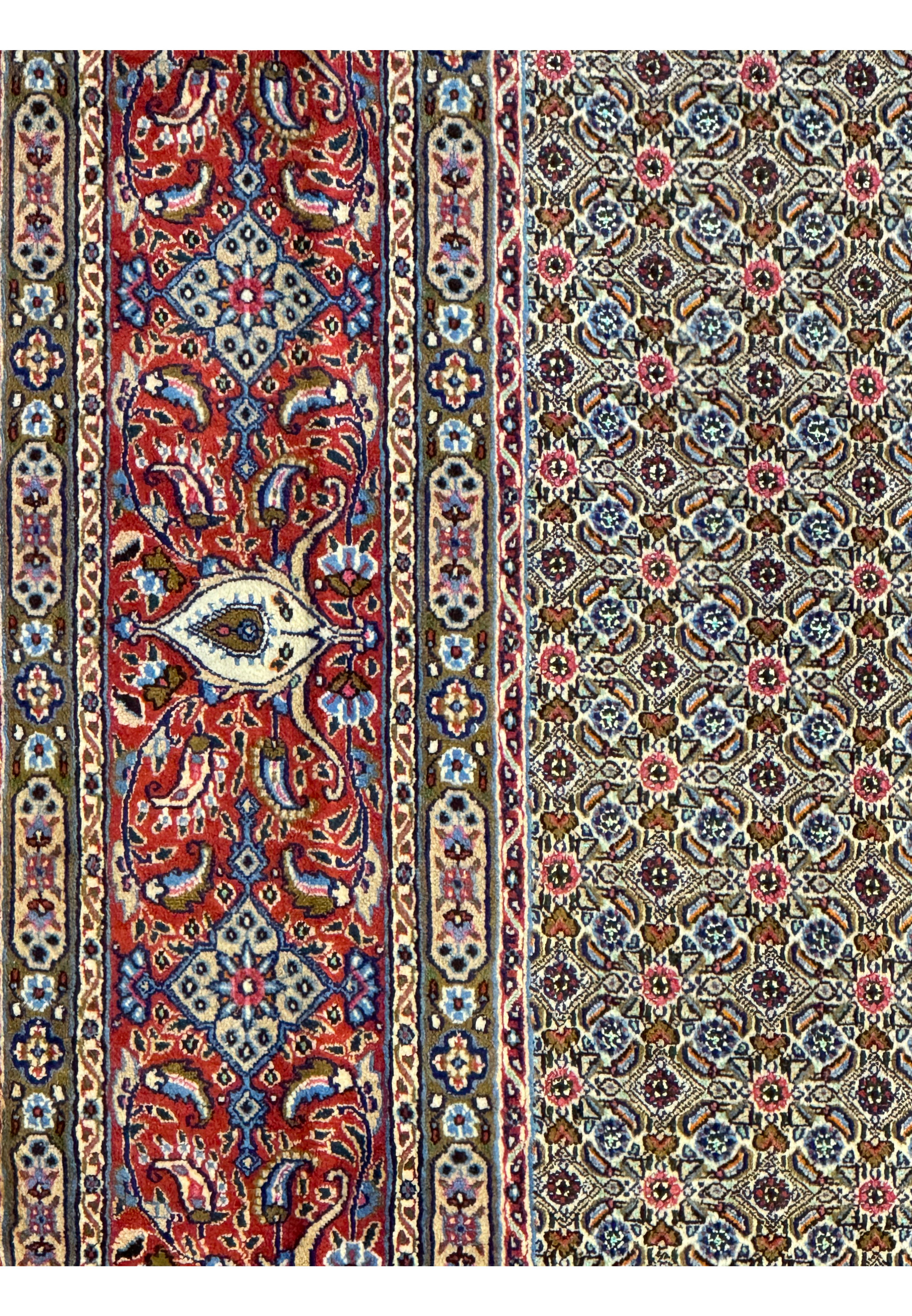 Detailed shot of the Persian Moud Rug's border featuring ornate floral designs and prominent medallions against a deep red backdrop
