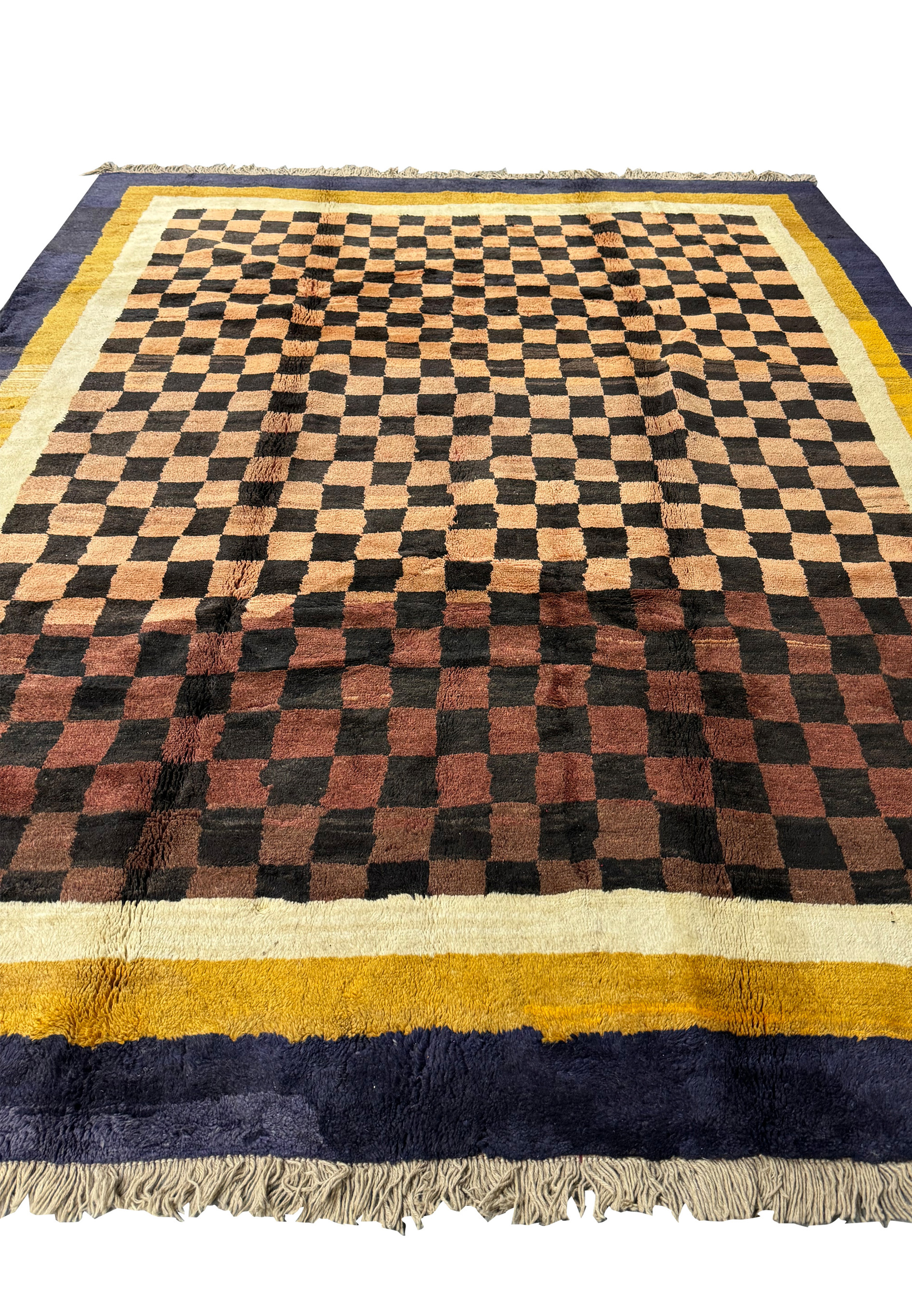 Angled perspective of the modern Nepal rug, emphasizing the bold checkerboard design and contrasting indigo and golden yellow border.
