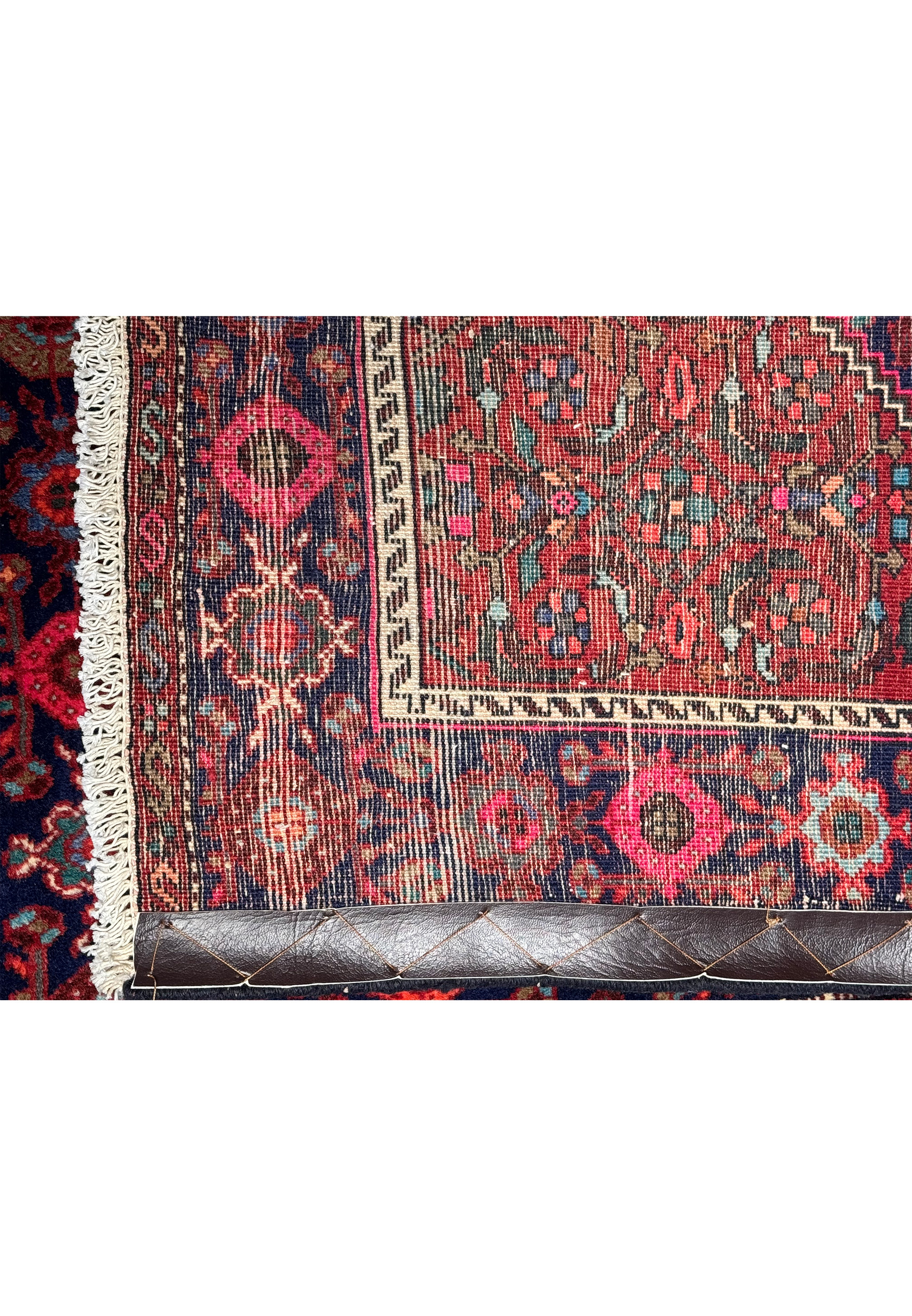 The vibrant color palette and refined details of a Persian Gholtogh rug's weave captured from a low angle for a dynamic visual effect