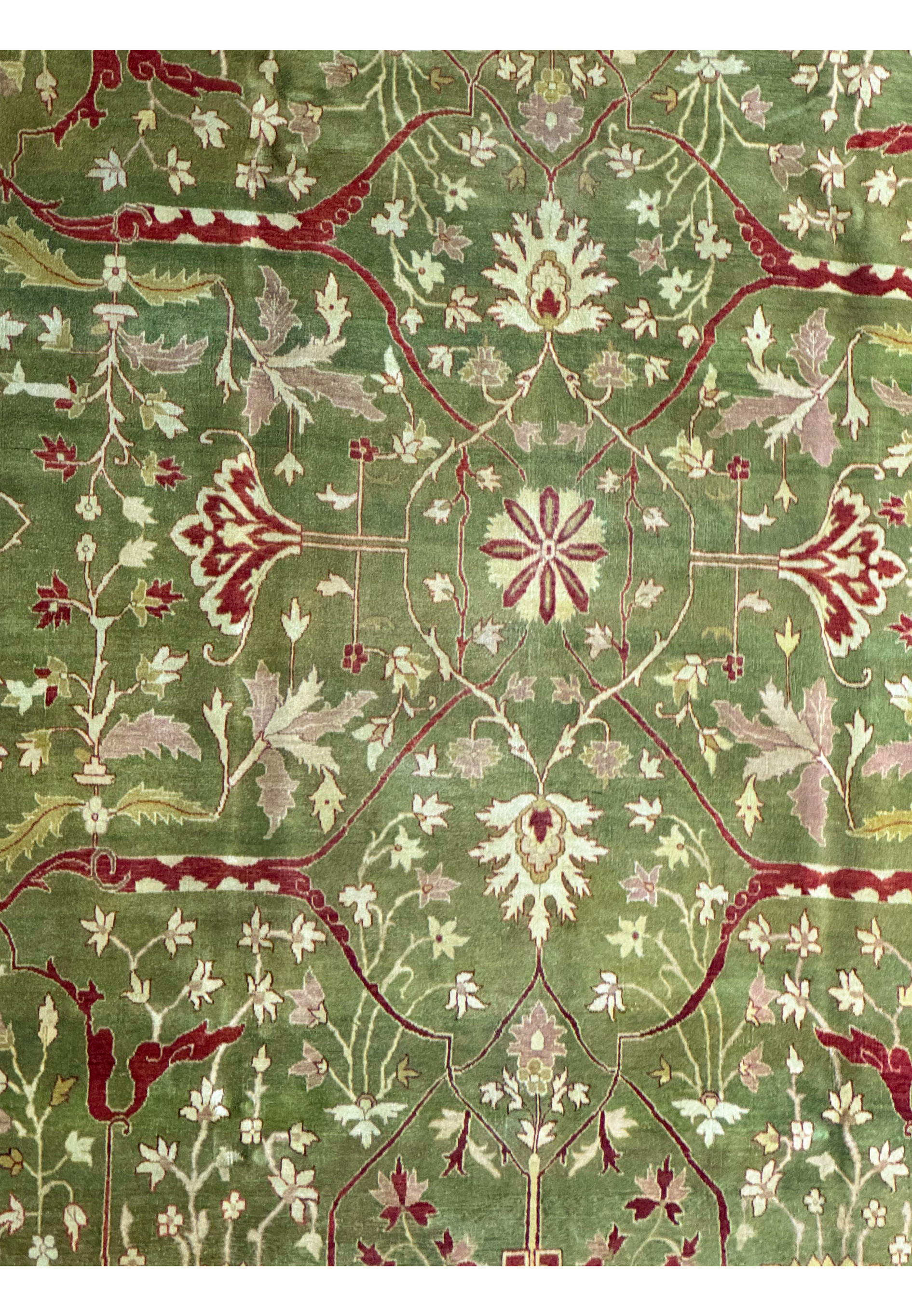 Full view of a traditional 10x15 Oriental Chobi Peshawar rug with rich olive and burgundy tones and detailed floral patterns