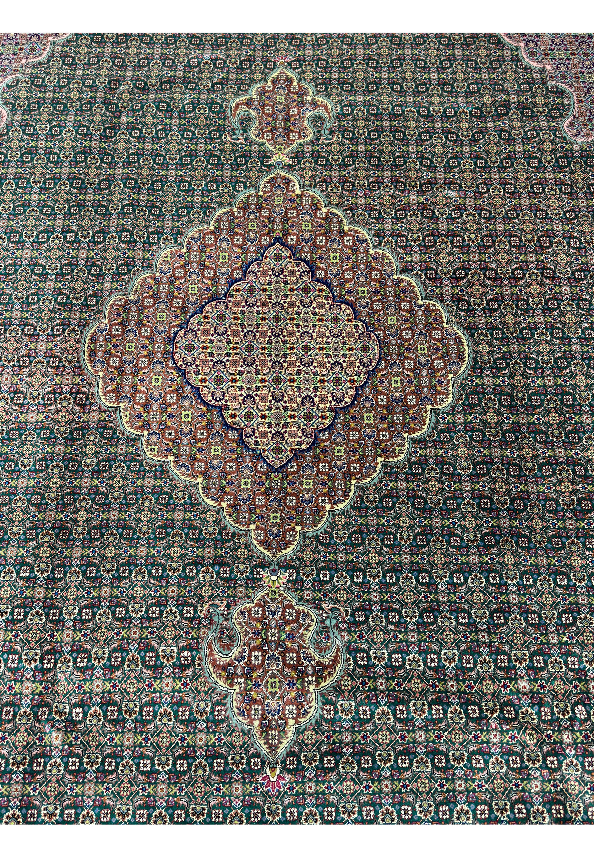Elegant Persian Tabriz rug with green and cream accents and traditional Mahi design.