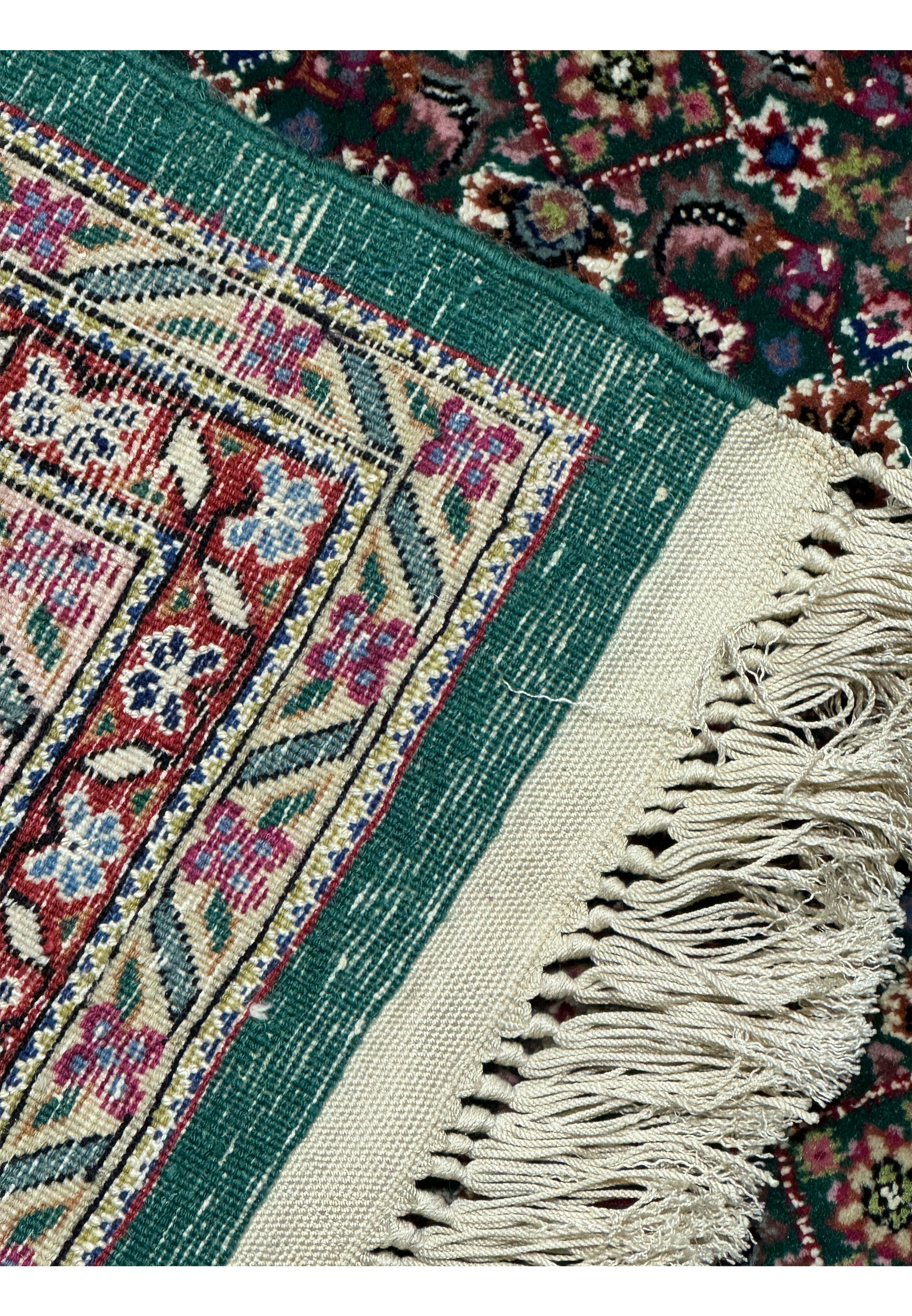 Fringed edge of a Persian Tabriz rug revealing the quality of hand-knotted construction