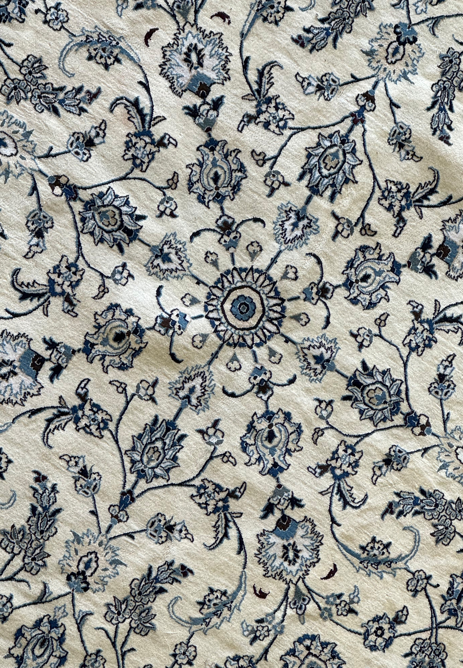 Close-up of the intricate silk and wool blend in a Persian Nain rug.