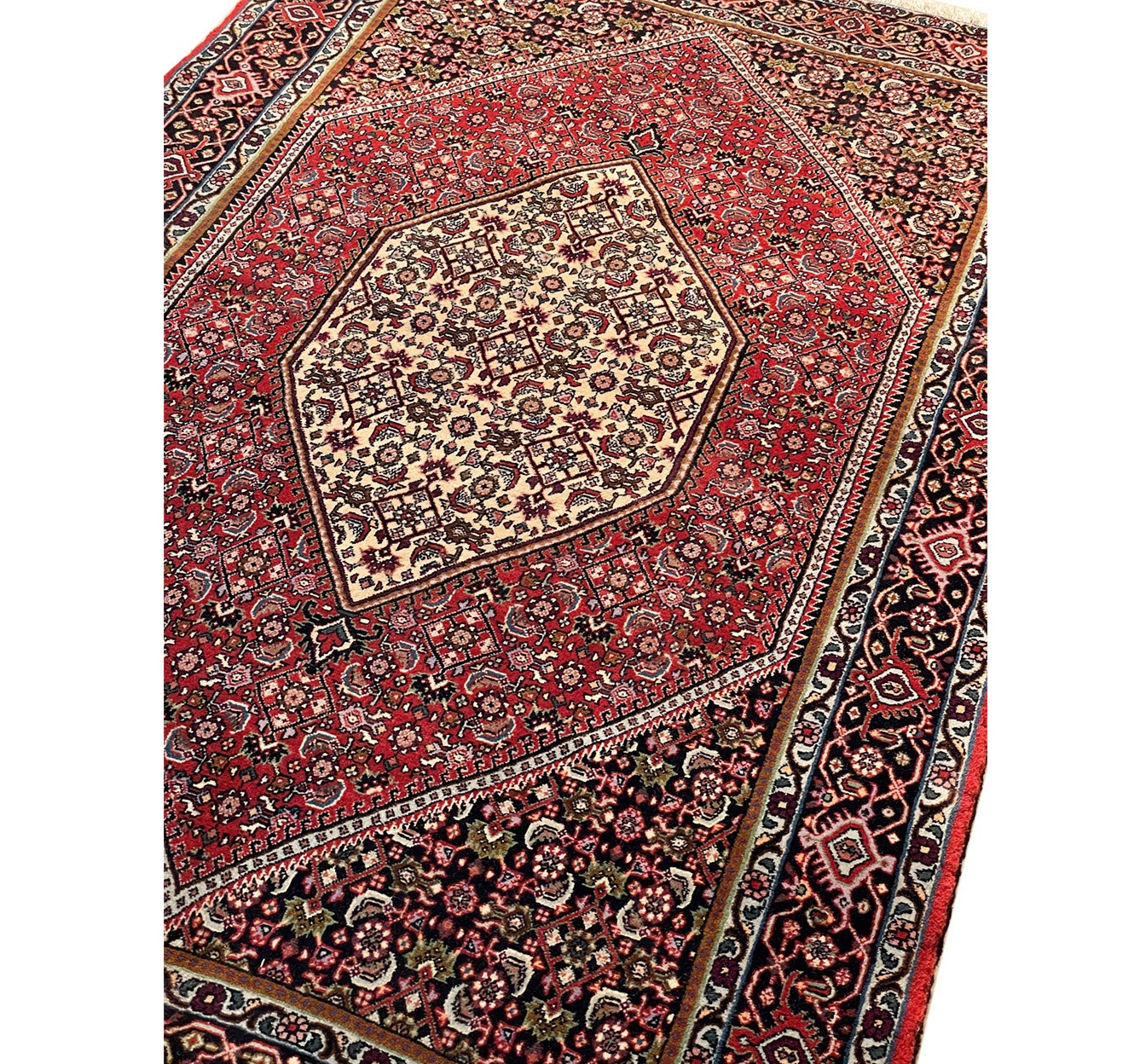 Angled view of a Persian Bijar rug, highlighting the plush pile and detailed motifs