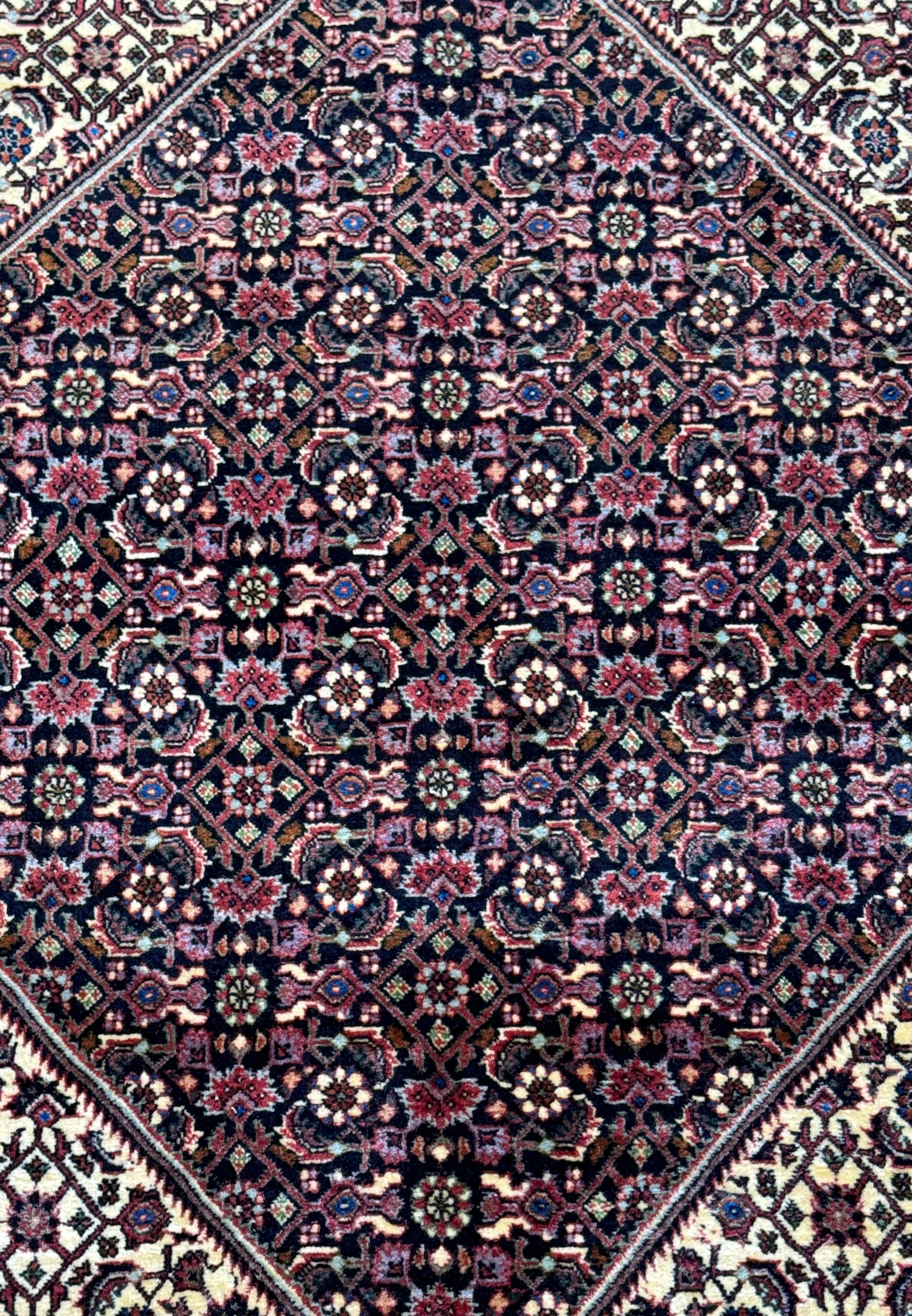 Close-up of the richly detailed patterns on a 13x13 Persian Bidjar rug, showcasing intricate floral designs and a vibrant color palette.