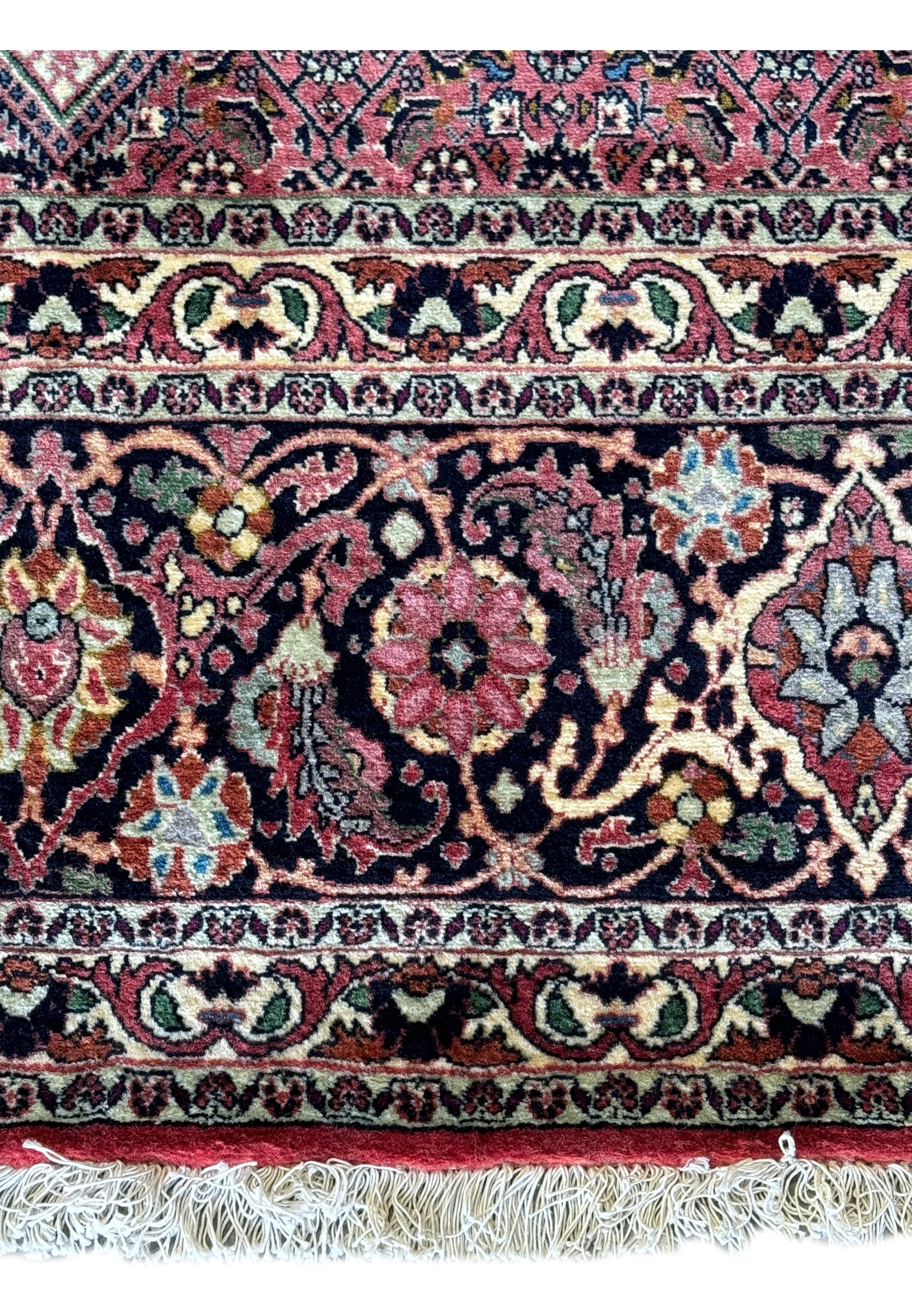Diagonal view of a Persian Bijar rug, revealing the nuanced color depth and the precision of its intricate patterns from corner to center.