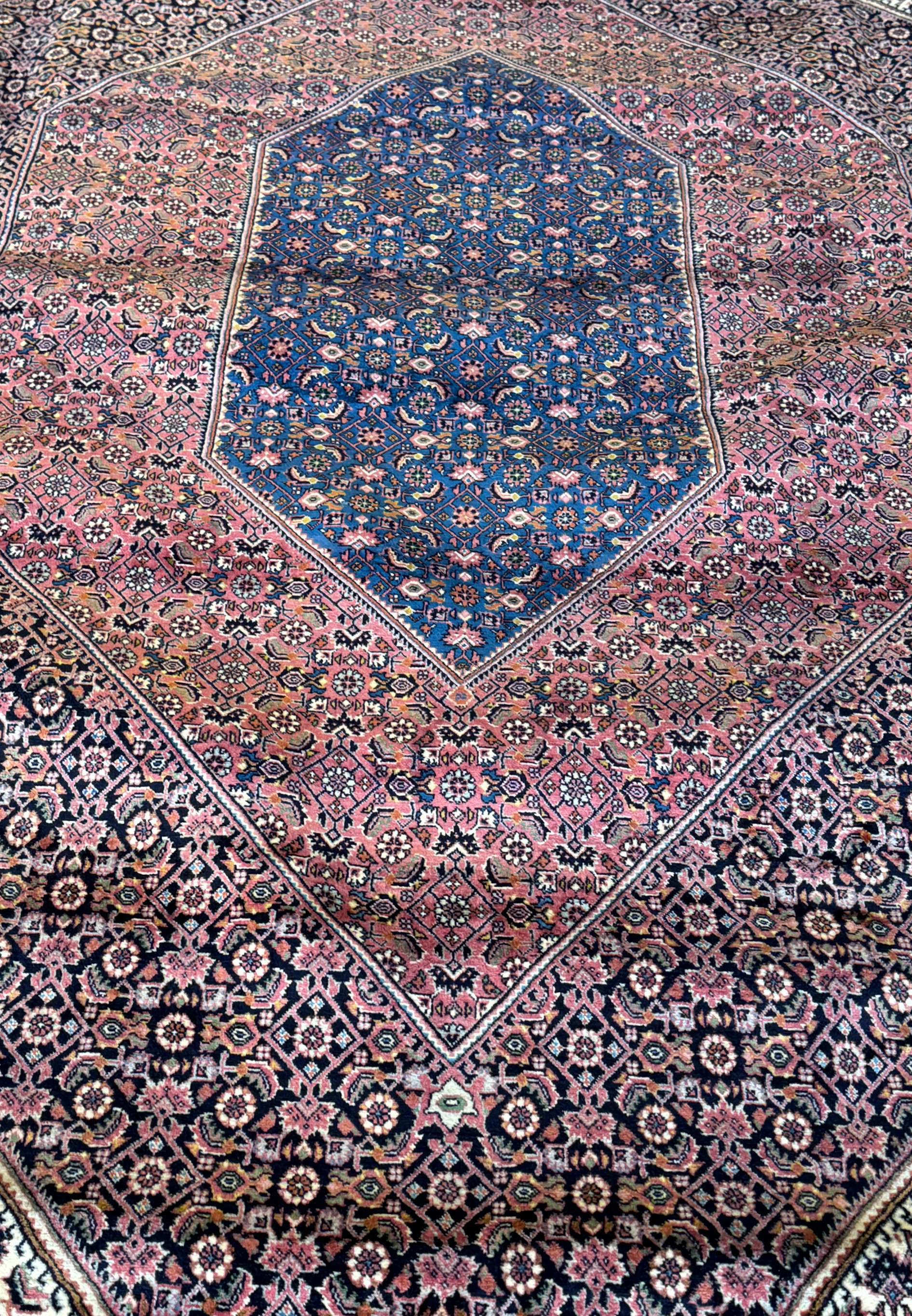 A captivating Persian Bijar rug, where the central medallion is surrounded by a mesmerizing array of symbols and details, each intricately handwoven into the fabric to create a work of art