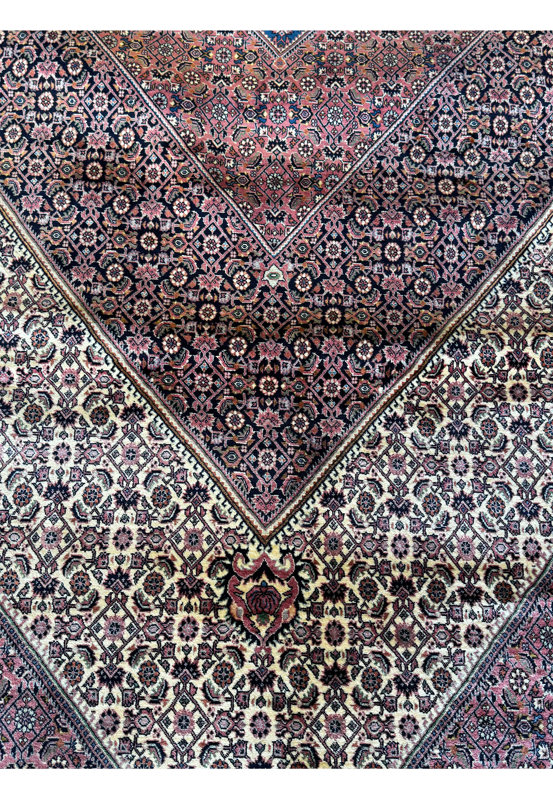 The central medallion on this 12x17 Bijar Persian rug is a masterpiece of design, featuring an ornate composition of intricate motifs and symbols that epitomize the artistry of Persian rug-making