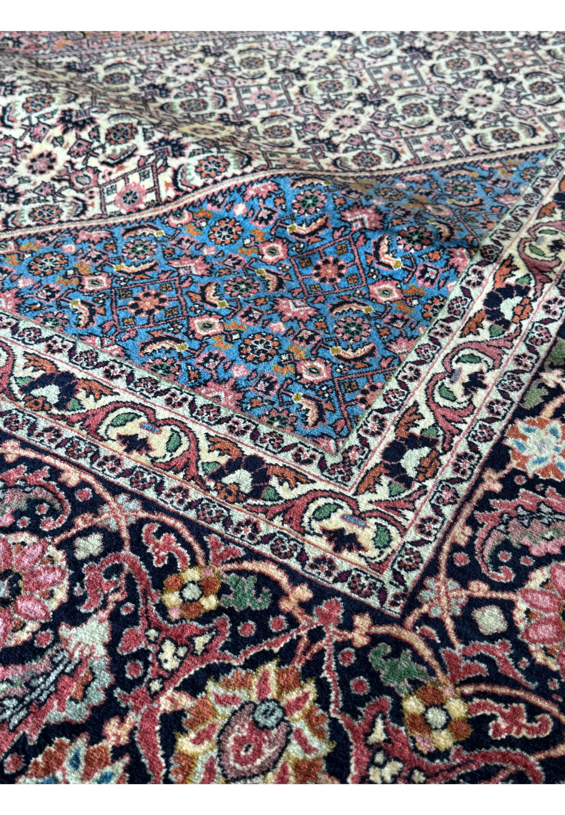 A 12x17 Bijar Persian rug featuring a central medallion surrounded by an elaborate pattern of intricate floral and geometric motifs, handwoven with exceptional craftsmanship