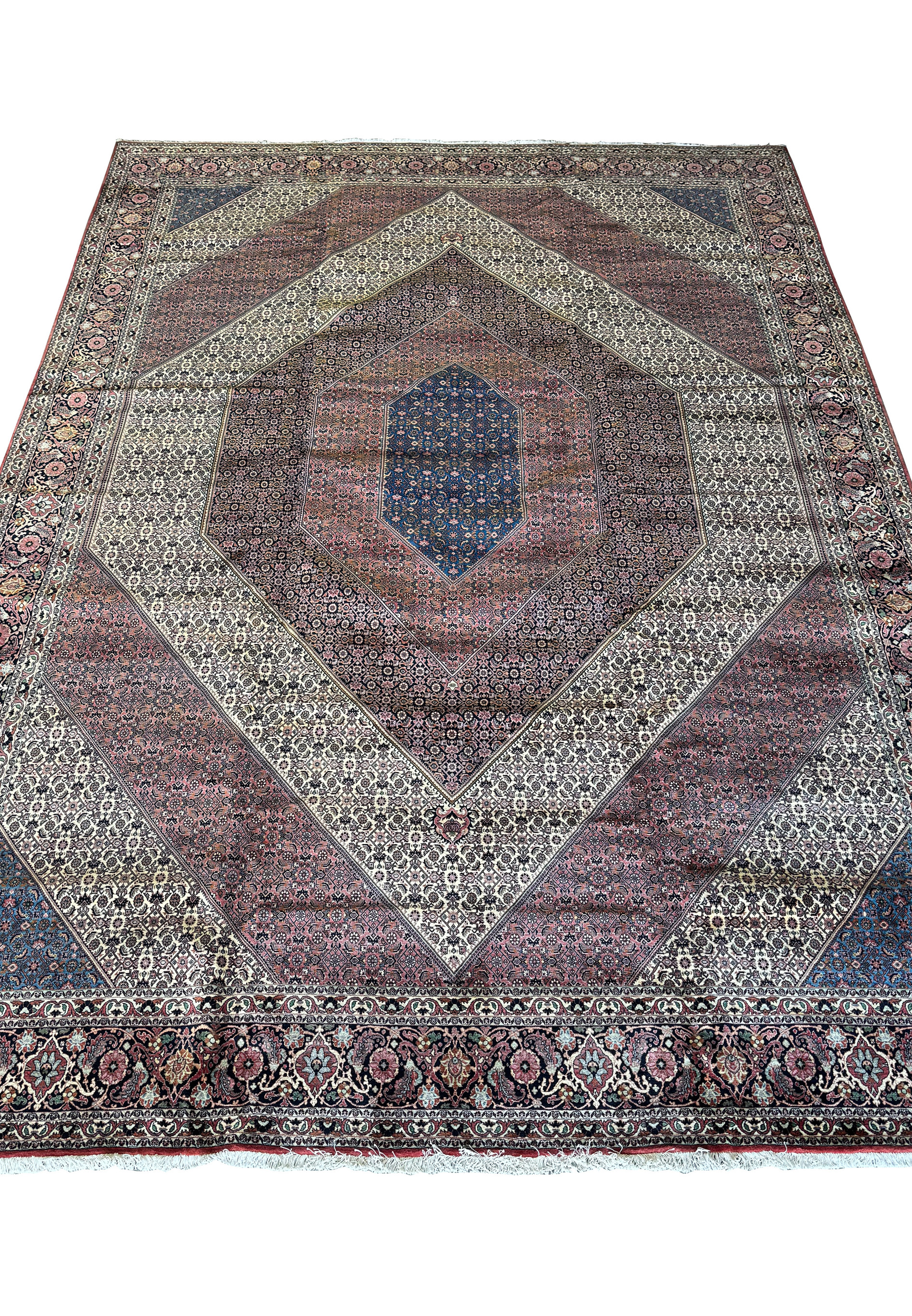 Detailed perspective of the Persian Bijar rug's ornate border and fringe, highlighting the quality of the weave and vibrancy of colors.