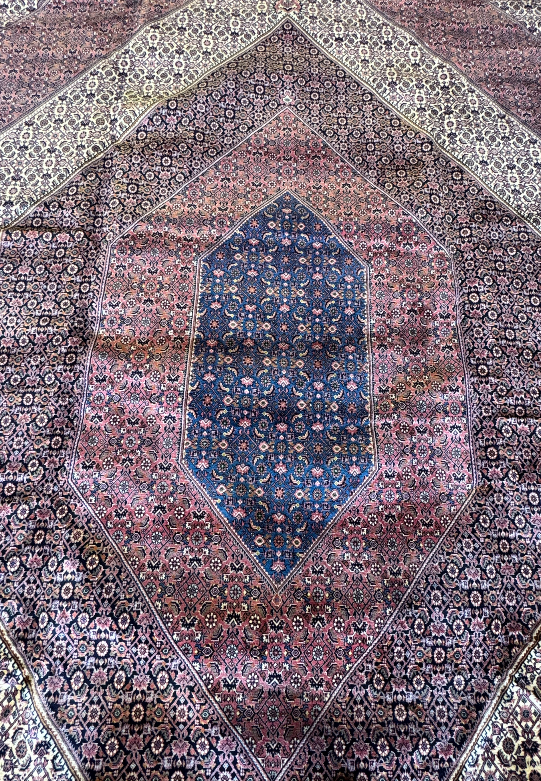 Dive into the world of Persian artistry with this Bijar rug, where the central medallion takes center stage, surrounded by a tapestry of symbols and detailed patterns woven into every inch of the rug