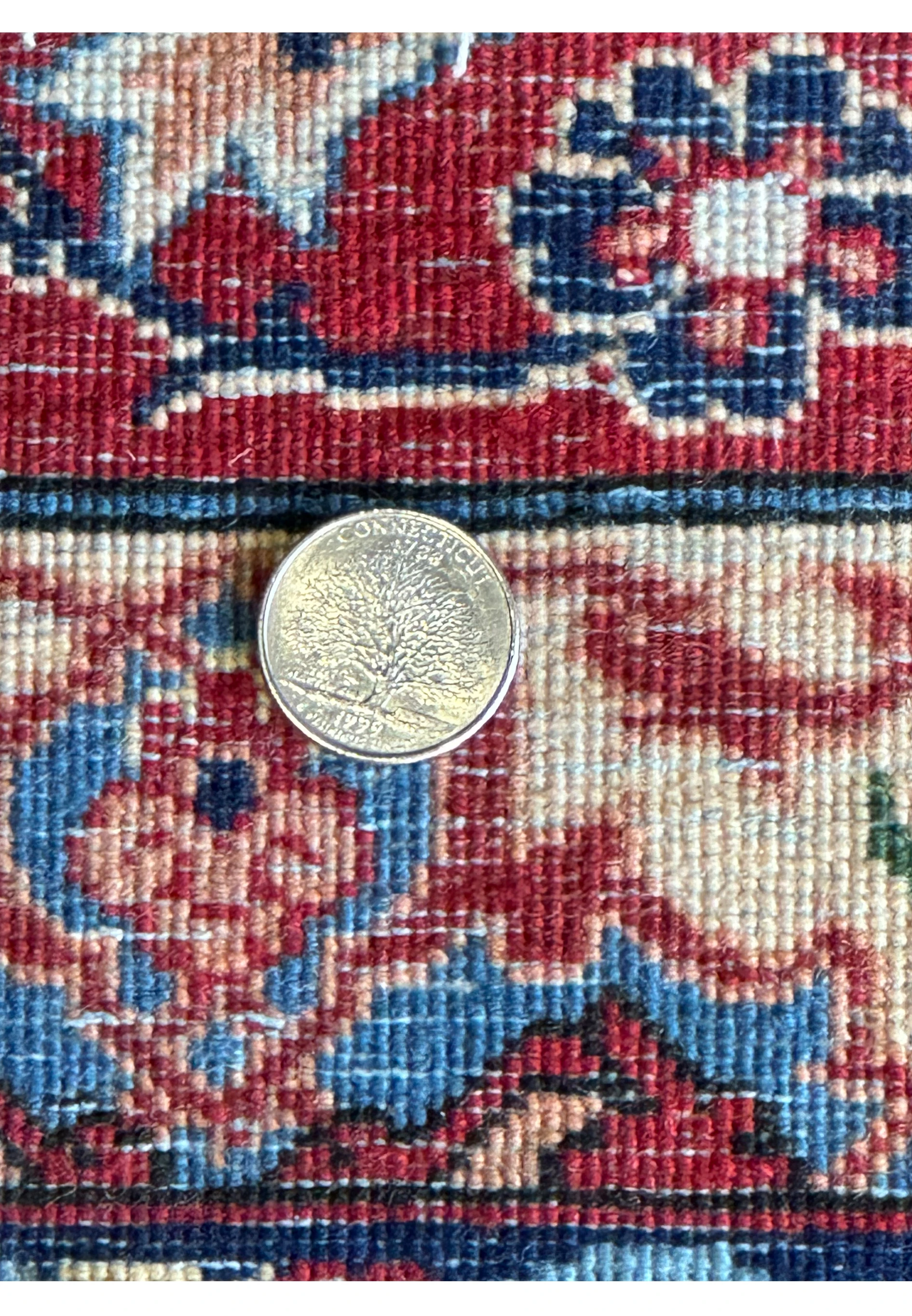 Diagonal view of a 10'7 x 14'7 Persian Isfahan Wool & Silk Rug, focusing on the transition from the central field to the border design.