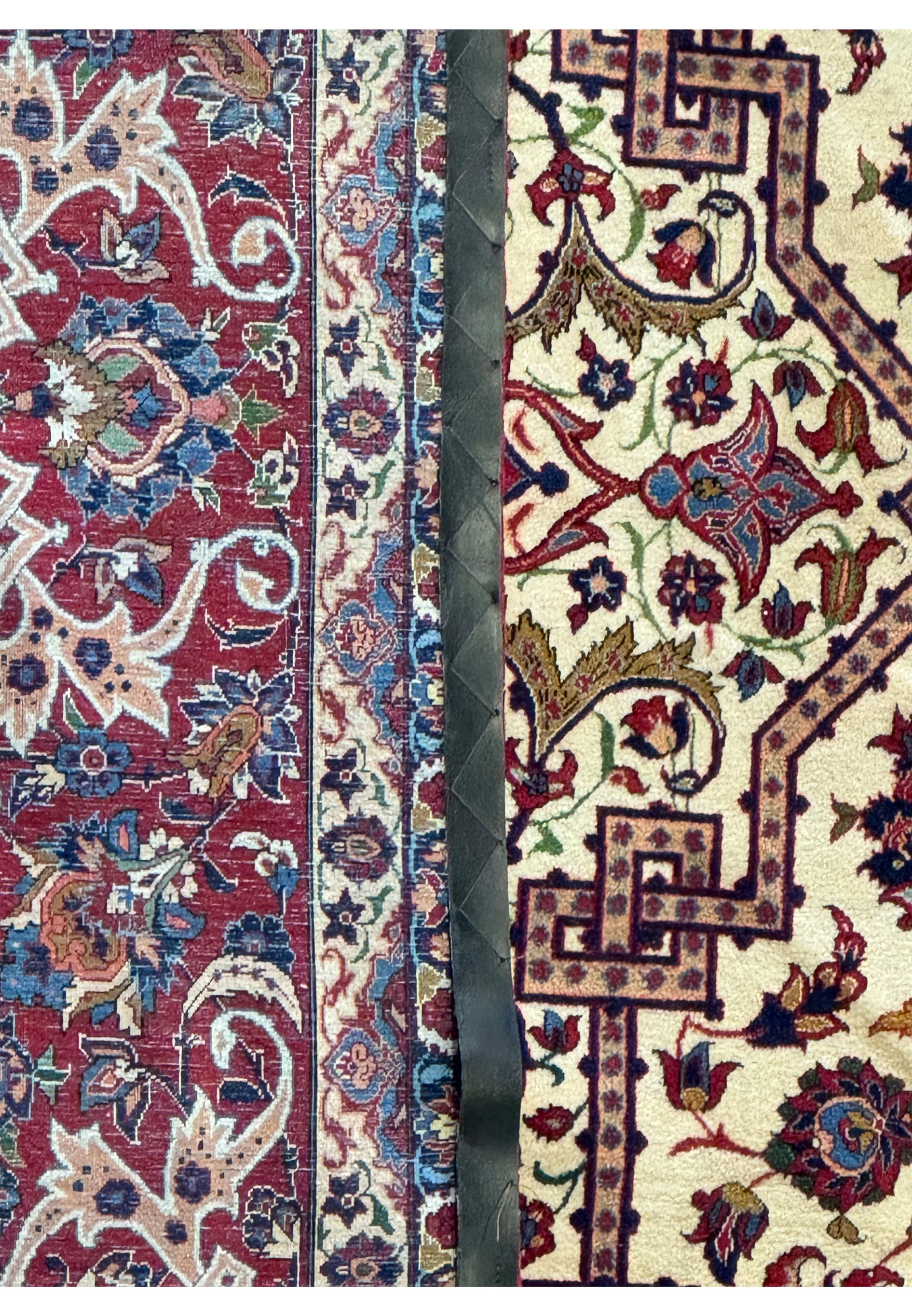 Macro shot of the intricate floral patterns on the border of a 10'7 x 14'7 Persian Isfahan Wool & Silk Rug, showing the detailed weave.