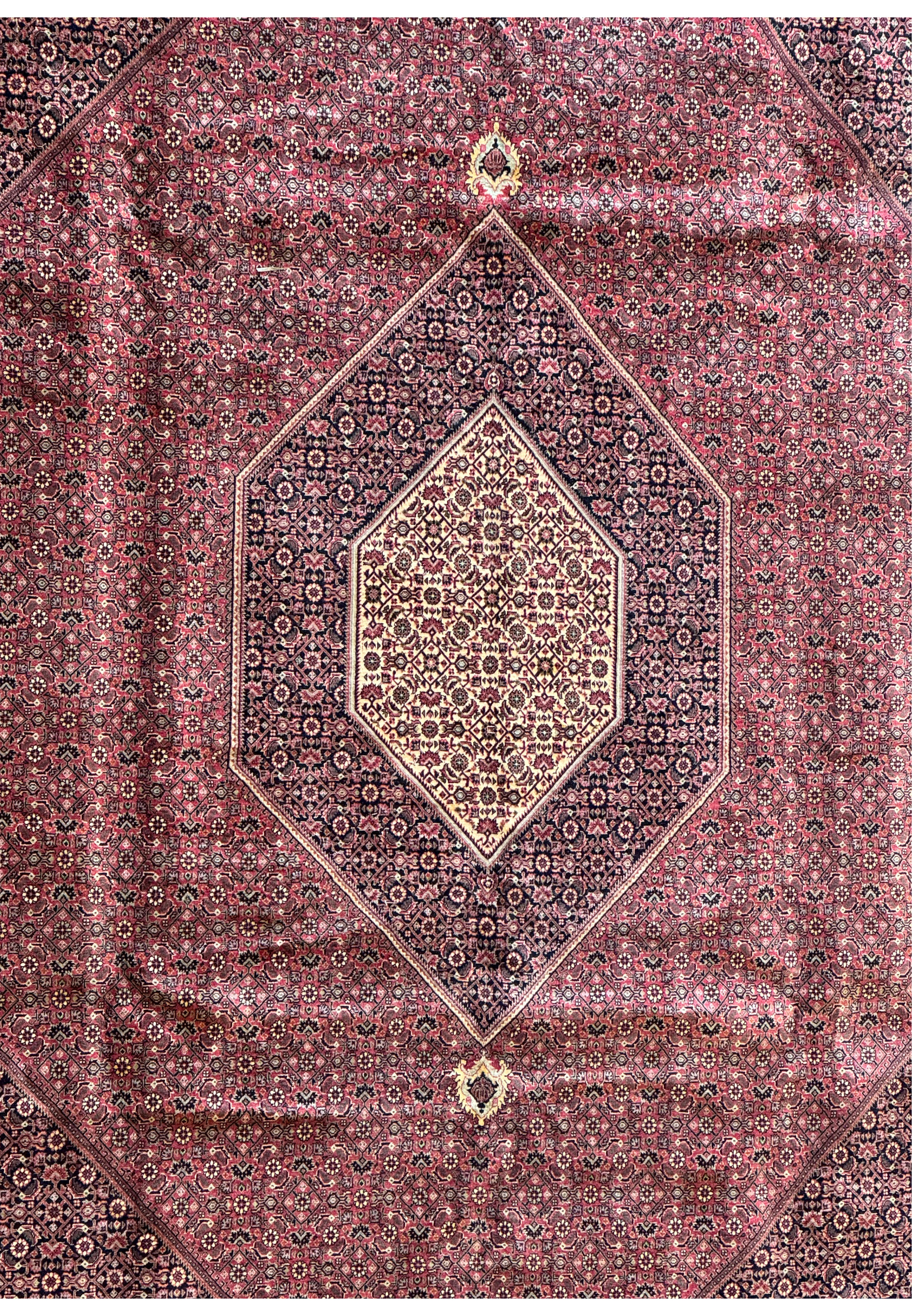 Detailed close-up of the central medallion on a 11'6x11'6 Persian Bijar square rug, with an array of meticulously crafted geometric shapes and vibrant color interplay