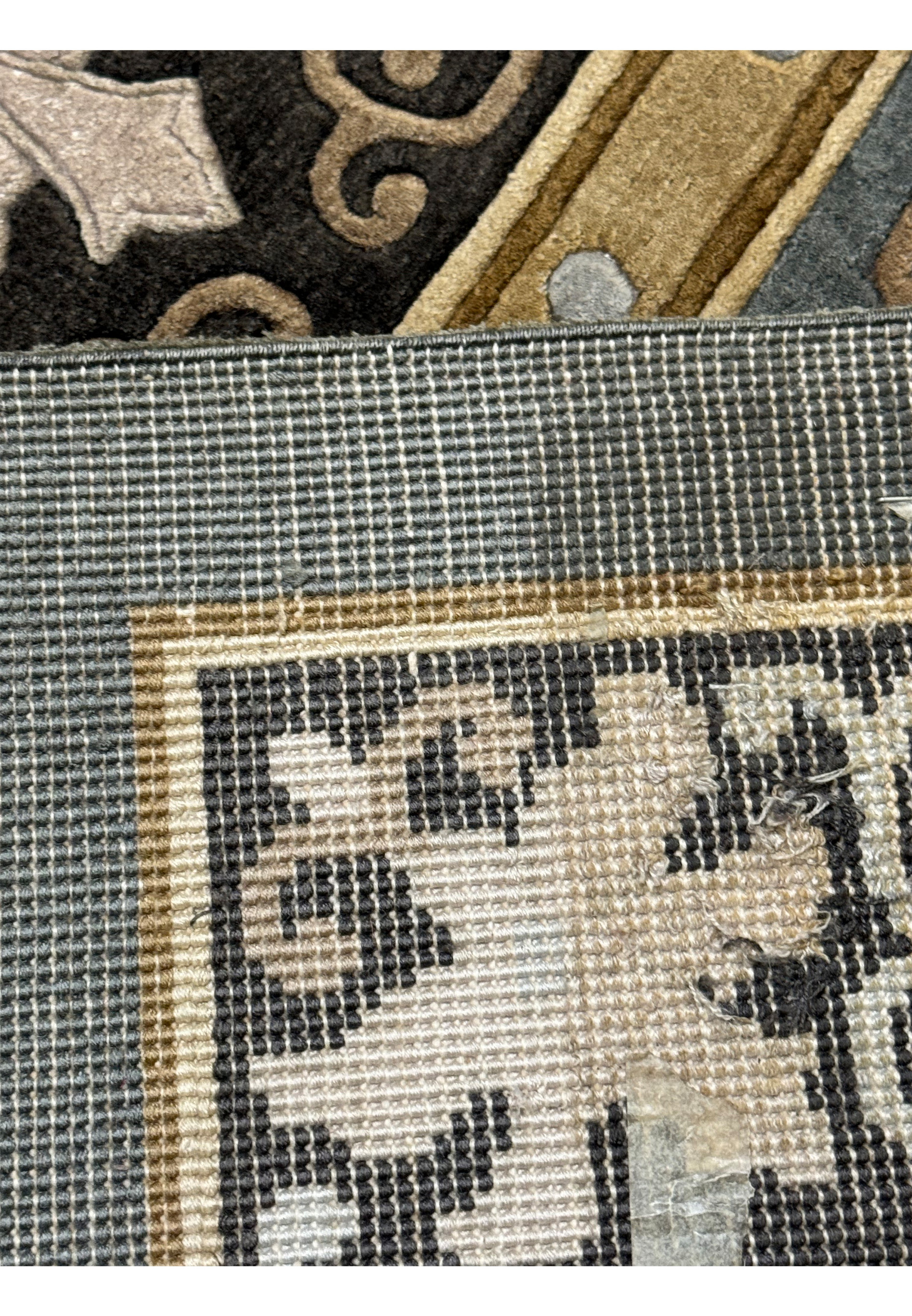 Macro detail of the Art Deco rug showcasing the fine silk work and the tight woolen weave.