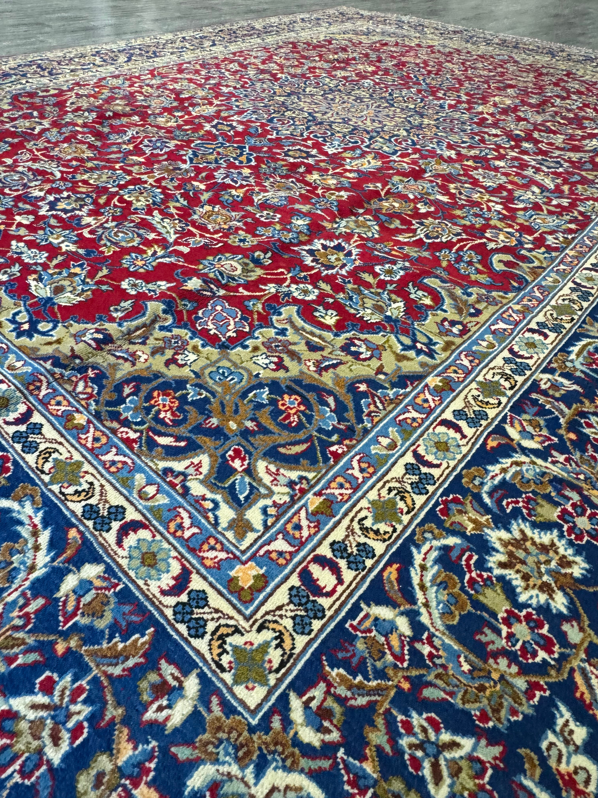 Angled side view of the Persian Isfahan rug laid flat, accentuating the three-dimensional texture and the sheen of the wool fibers, with the elaborate patterns slightly distorted by the perspective.
